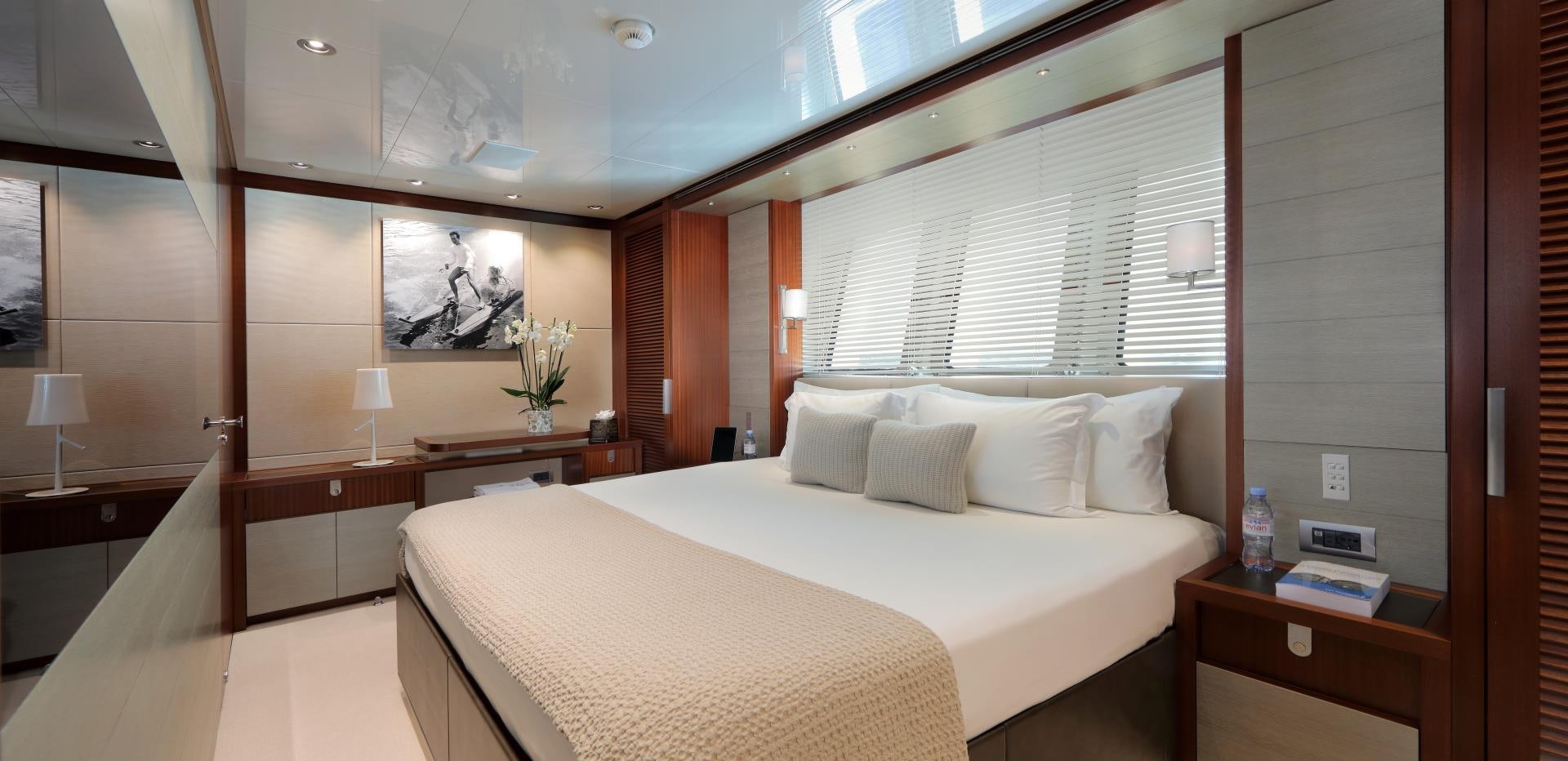a room with a bed and a desk aboard X Yacht for Sale