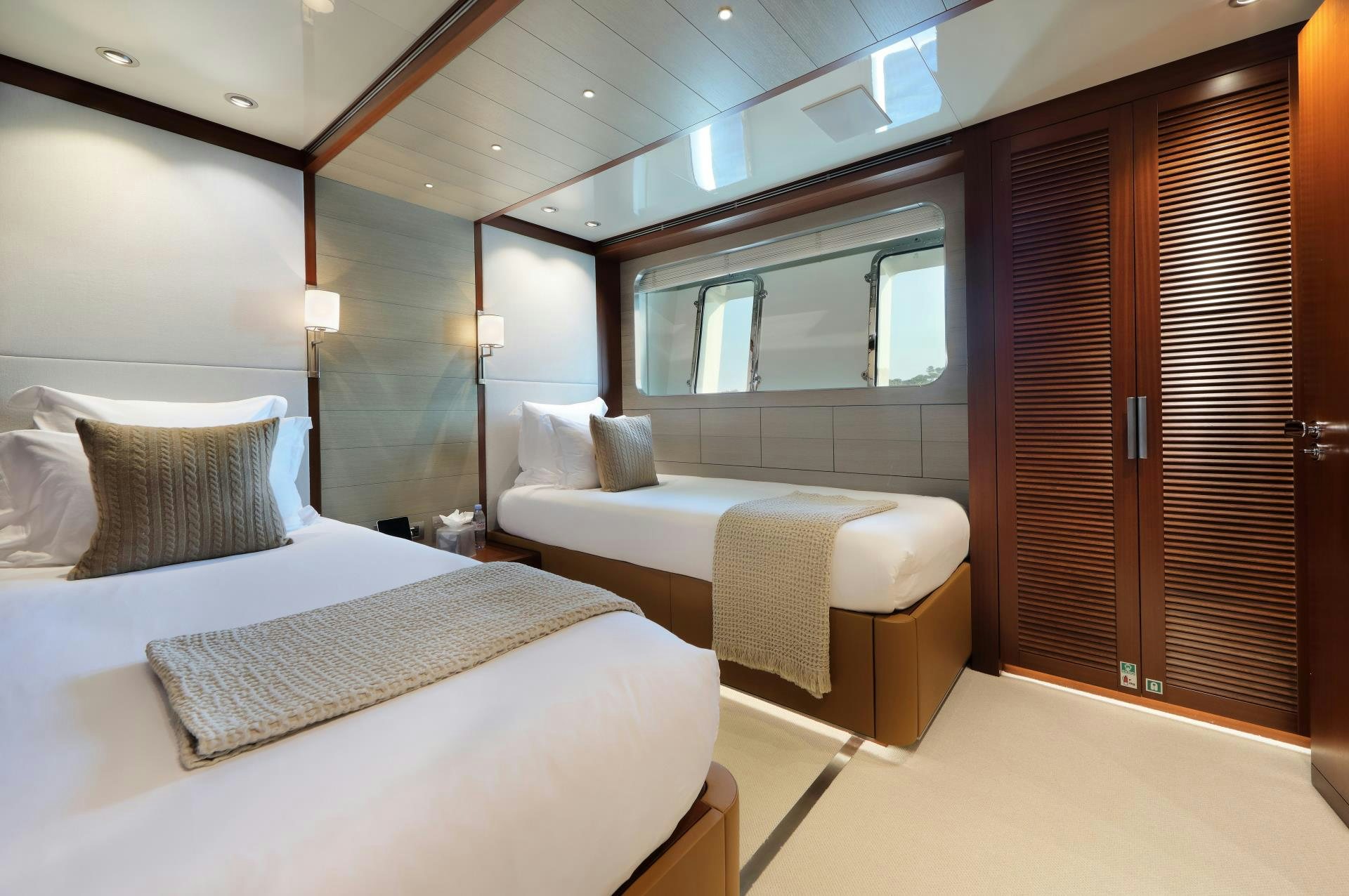 a room with two beds aboard X Yacht for Sale