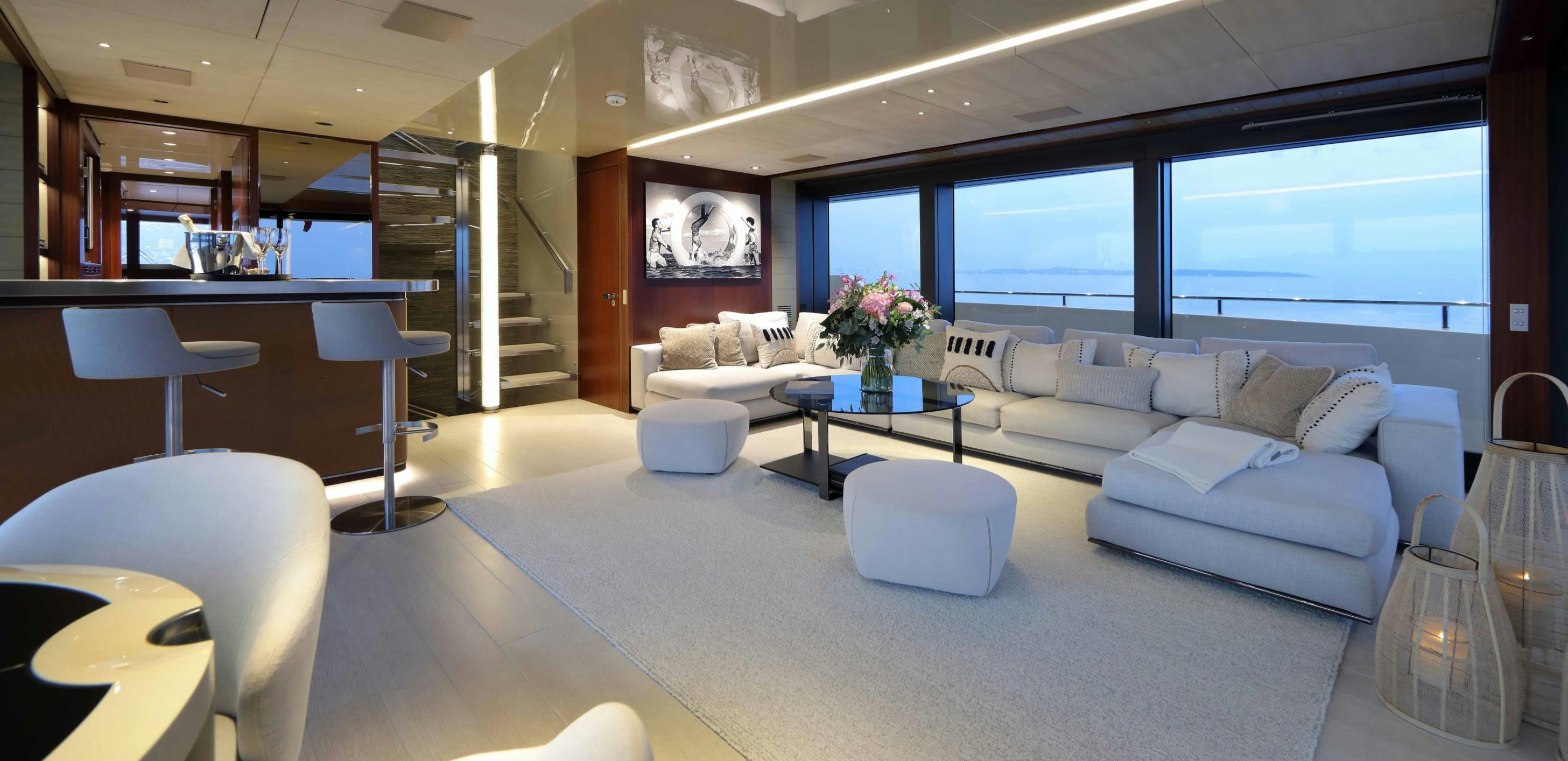 a living room with a couch and a table aboard X Yacht for Sale