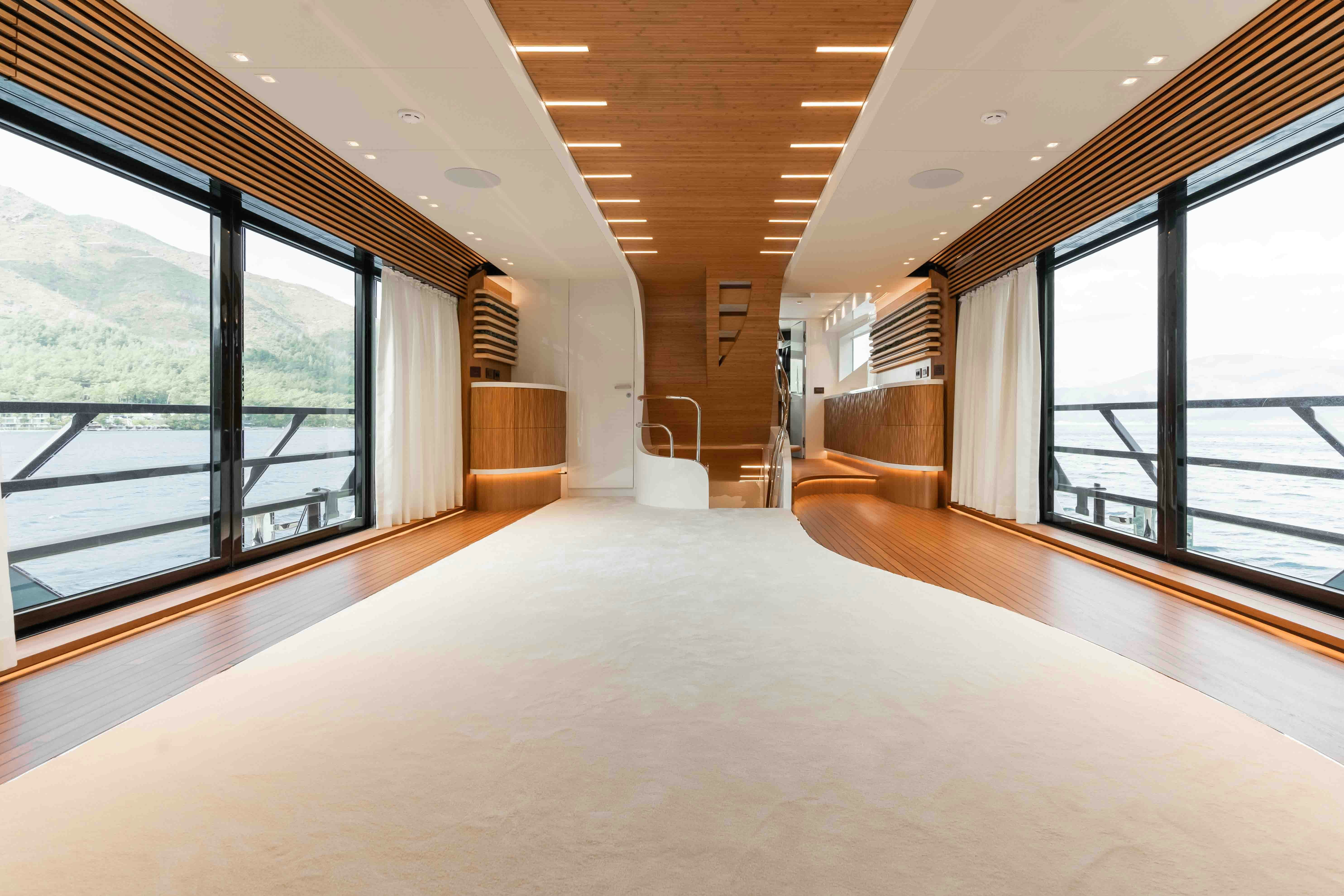 a large empty room with large windows aboard NB 202 Yacht for Sale