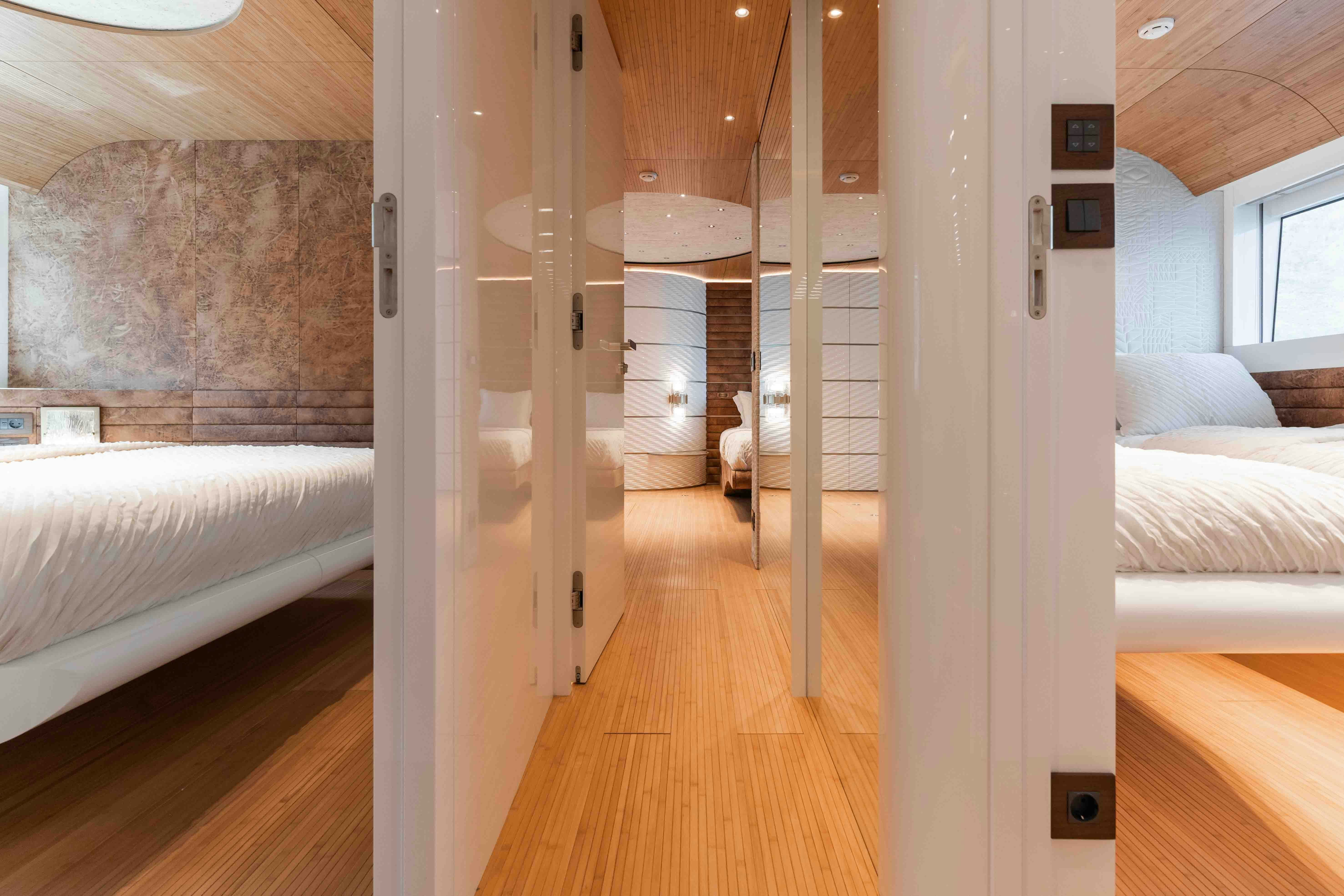 a room with a bed and a wood floor aboard NB 202 Yacht for Sale