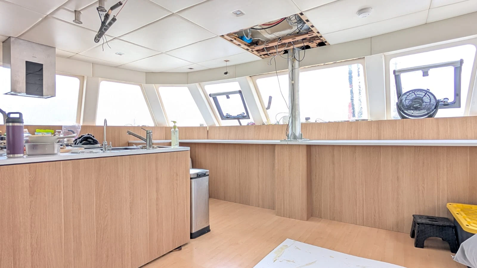 a kitchen with a wood floor aboard OCEAN ESCAPE Yacht for Sale