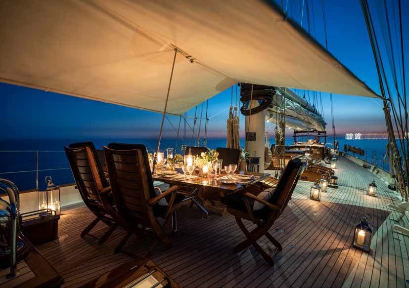 a table set for a dinner party aboard ALEXA OF LONDON Yacht for Charter
