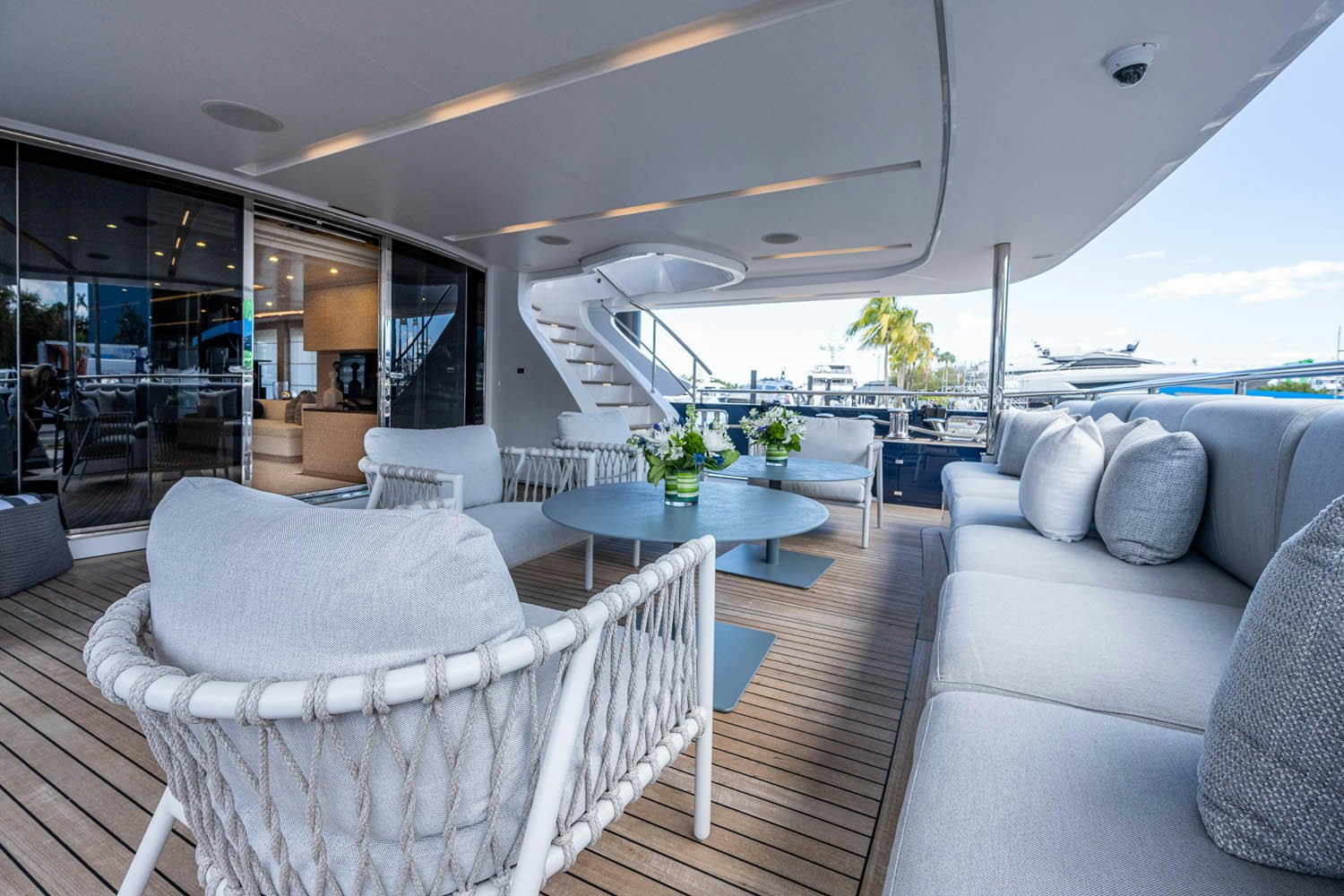 a large living room with a large balcony aboard COFINA Yacht for Charter