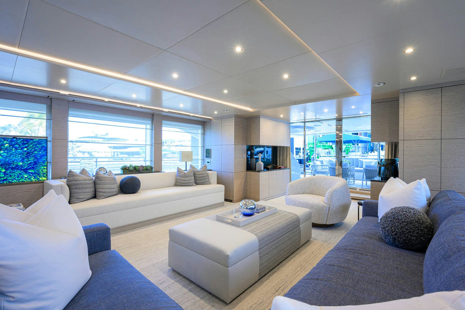 a living room with a large window aboard COFINA Yacht for Charter