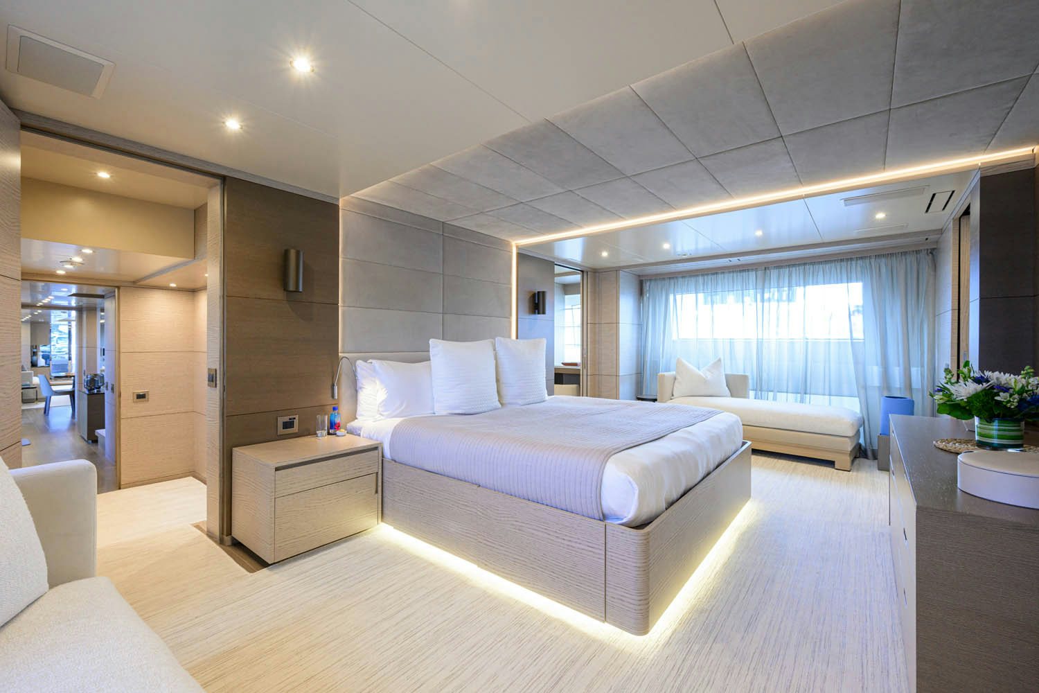 a room with a bed and a window aboard COFINA Yacht for Charter