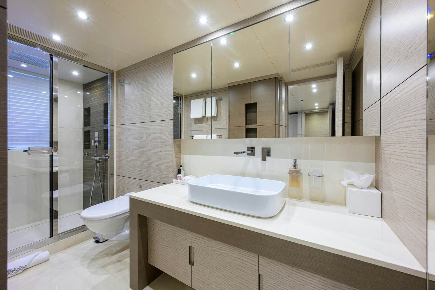 a bathroom with a large mirror aboard COFINA Yacht for Charter