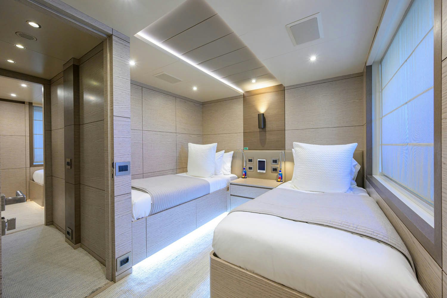 a room with a couple of beds aboard COFINA Yacht for Charter