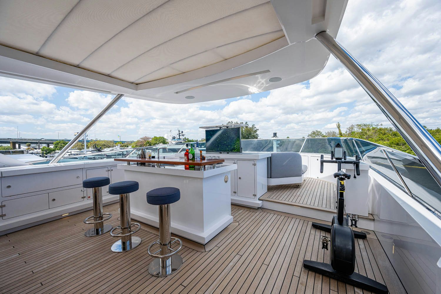 a large white boat with stools and stools on a deck aboard COFINA Yacht for Charter