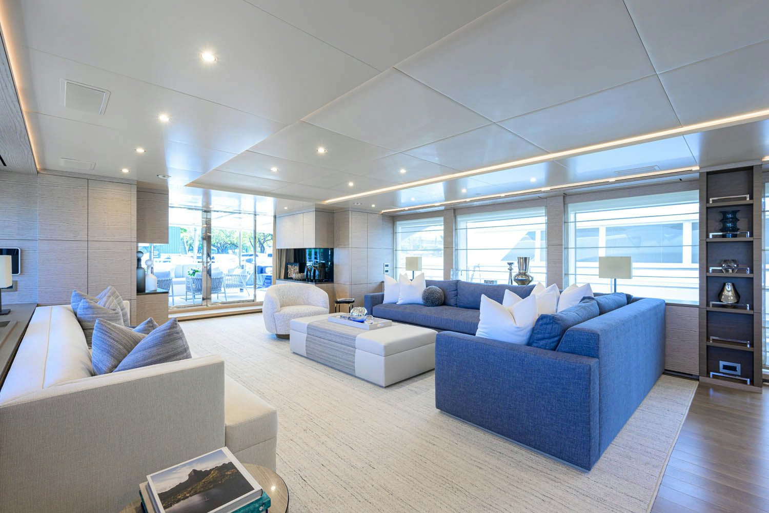 a living room with a large window aboard COFINA Yacht for Charter