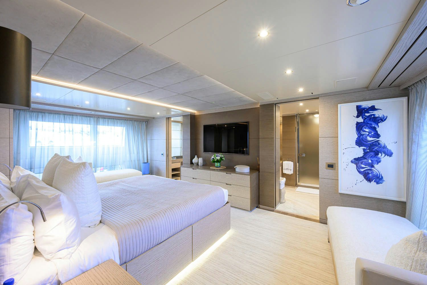 a bedroom with a bed and a tv aboard COFINA Yacht for Charter