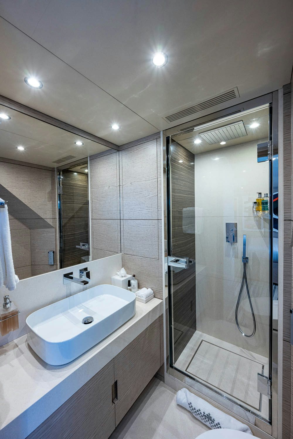 a bathroom with a large mirror aboard COFINA Yacht for Charter