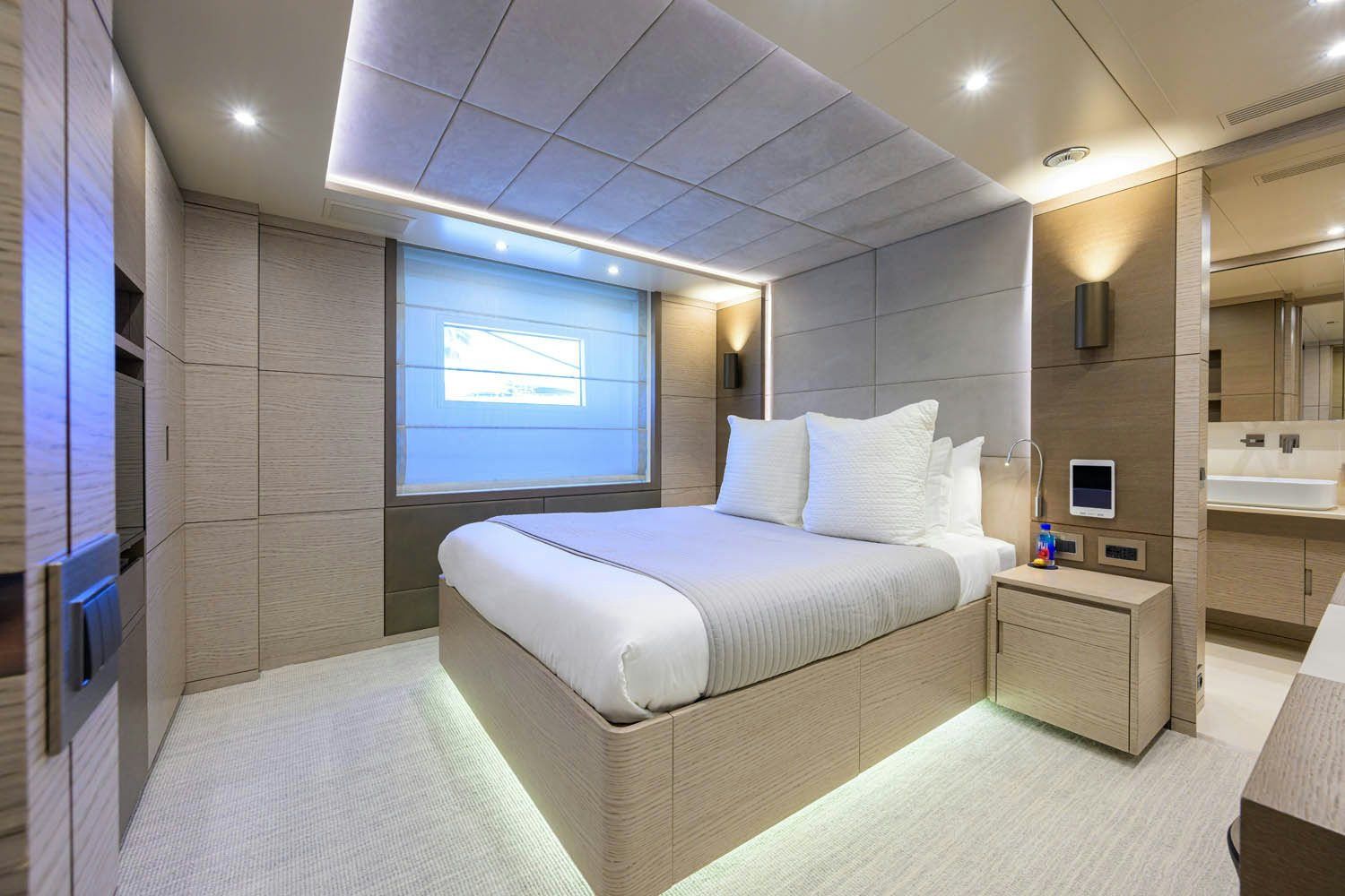 a room with a bed and a window aboard COFINA Yacht for Charter