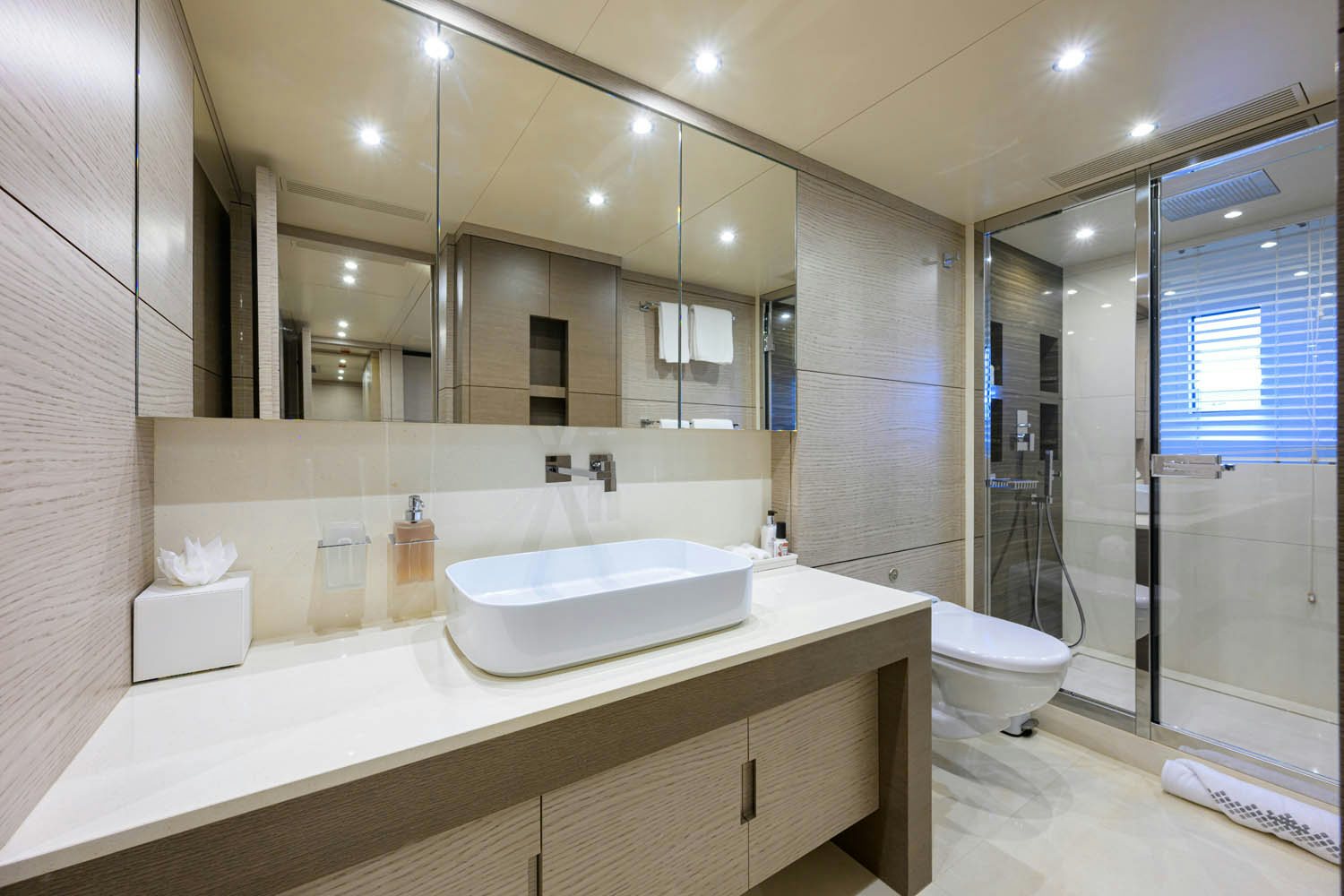 a bathroom with a large mirror aboard COFINA Yacht for Charter