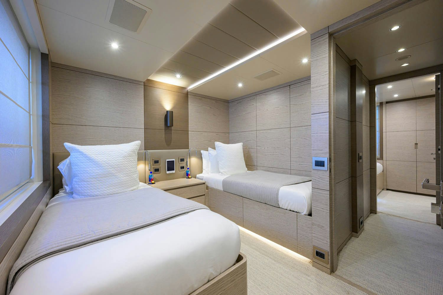 a room with a bed and a mirror aboard COFINA Yacht for Charter