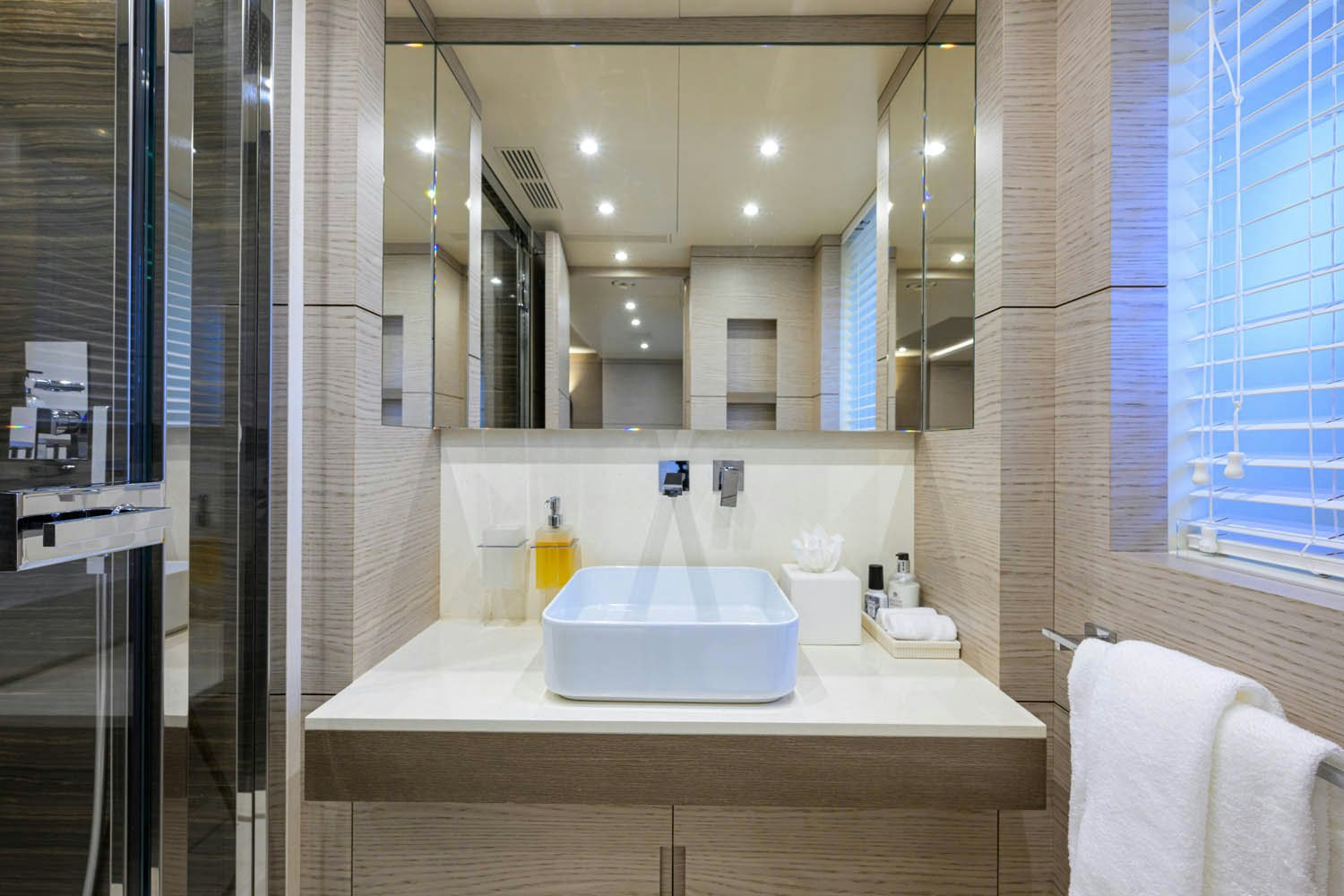 a bathroom with a large mirror aboard COFINA Yacht for Charter