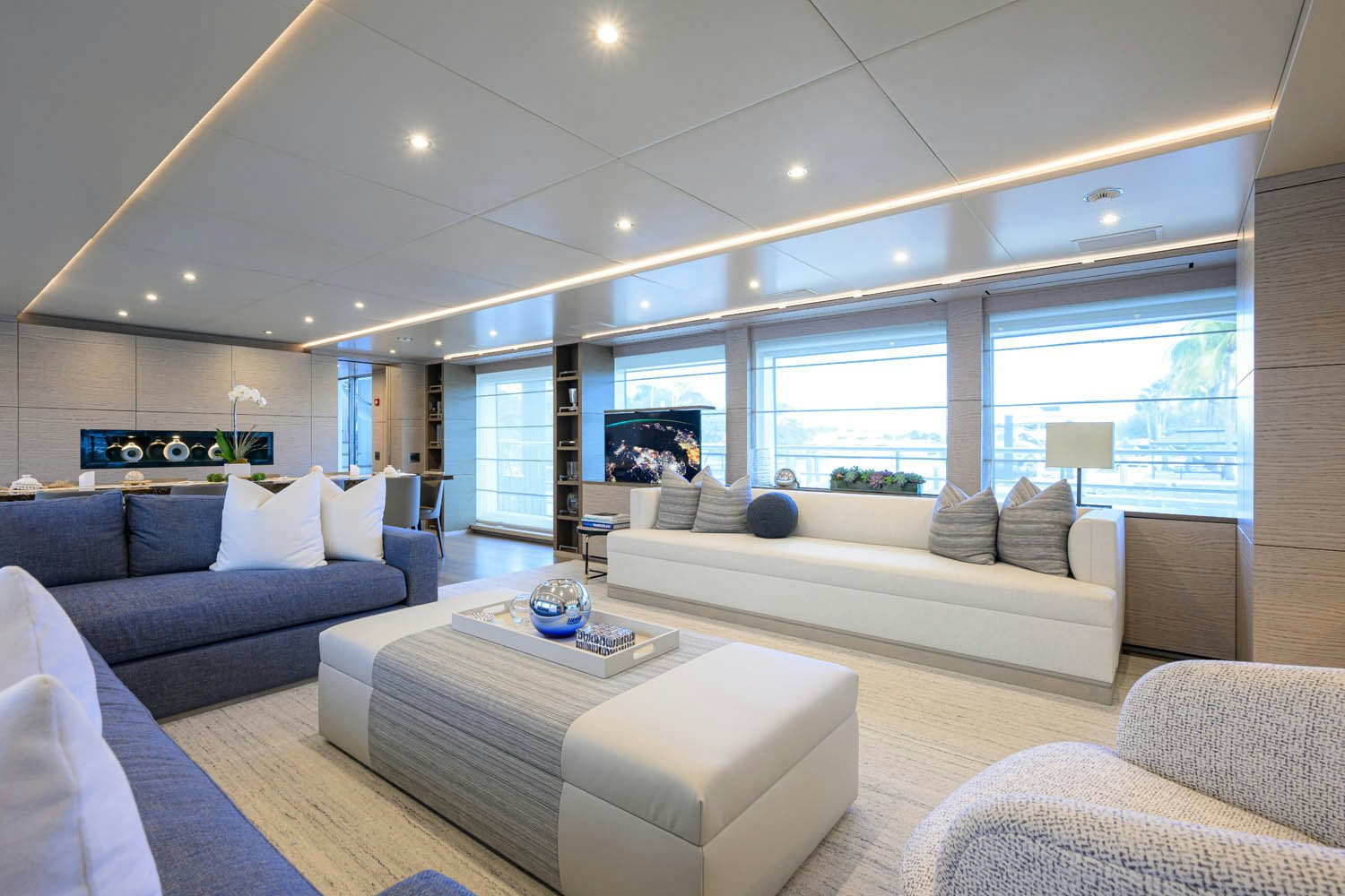 a living room with a large window aboard COFINA Yacht for Charter