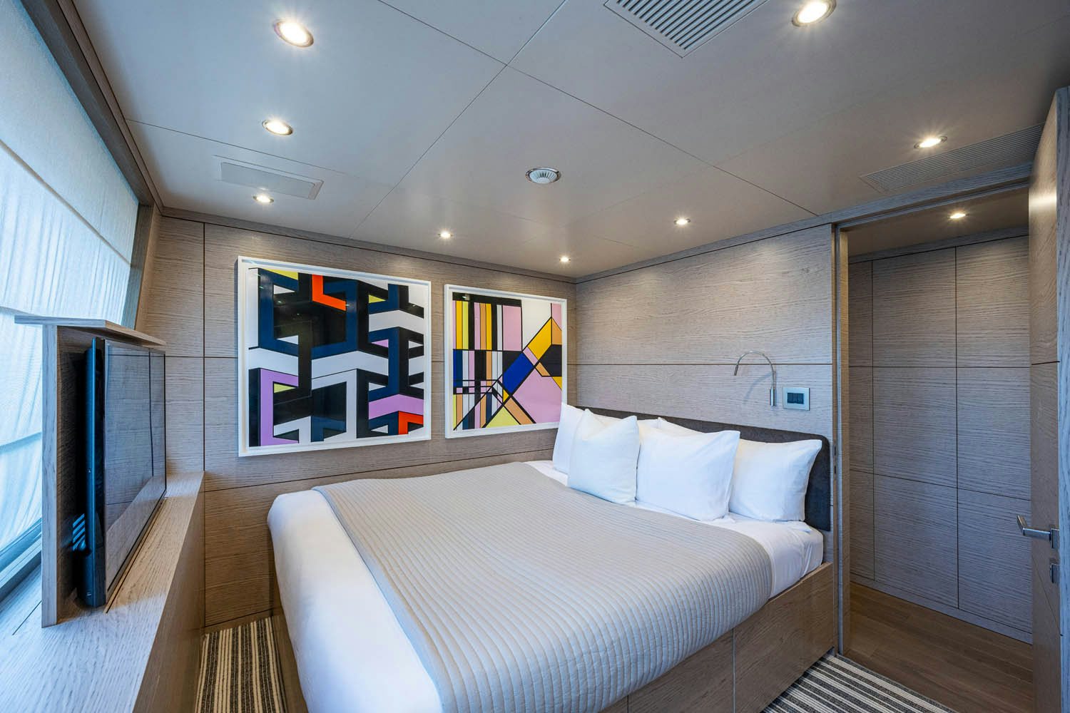 a bed in a room aboard COFINA Yacht for Charter