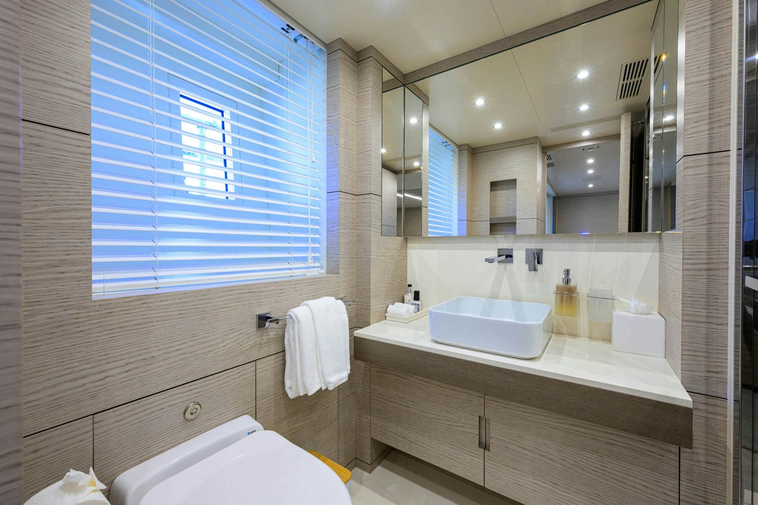a bathroom with a large mirror aboard COFINA Yacht for Charter