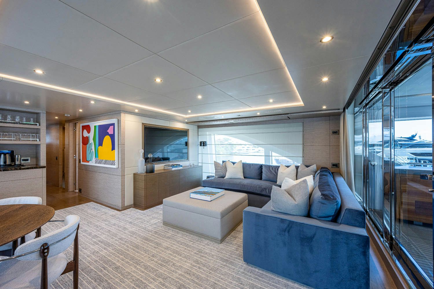 a living room with a large window aboard COFINA Yacht for Charter