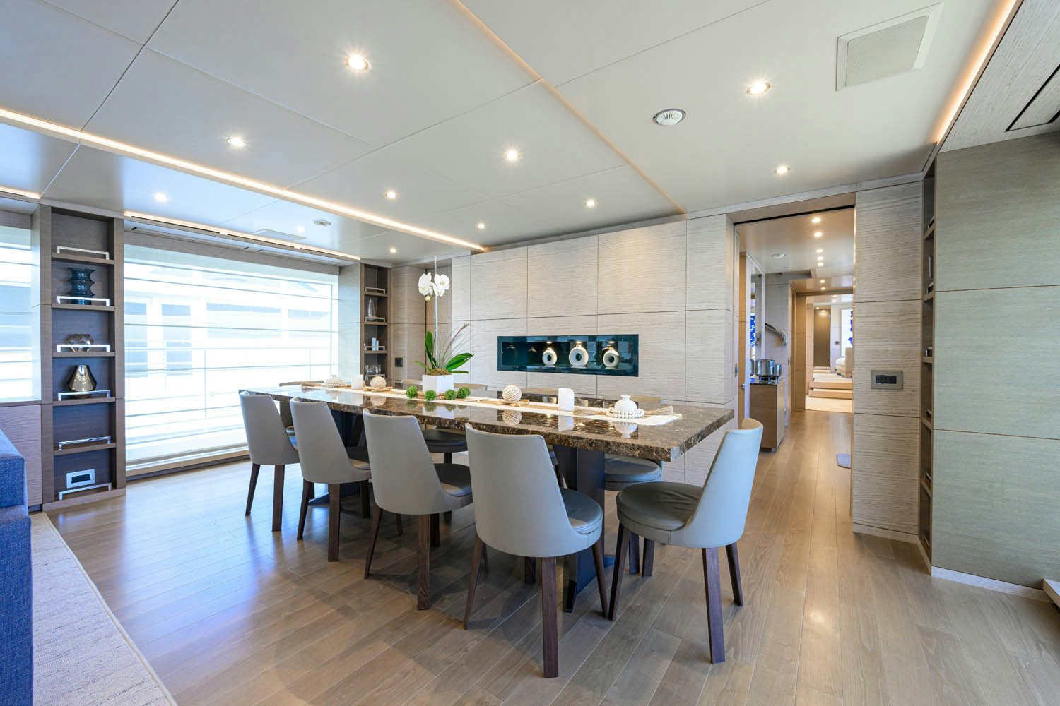 a large kitchen with white chairs aboard COFINA Yacht for Charter