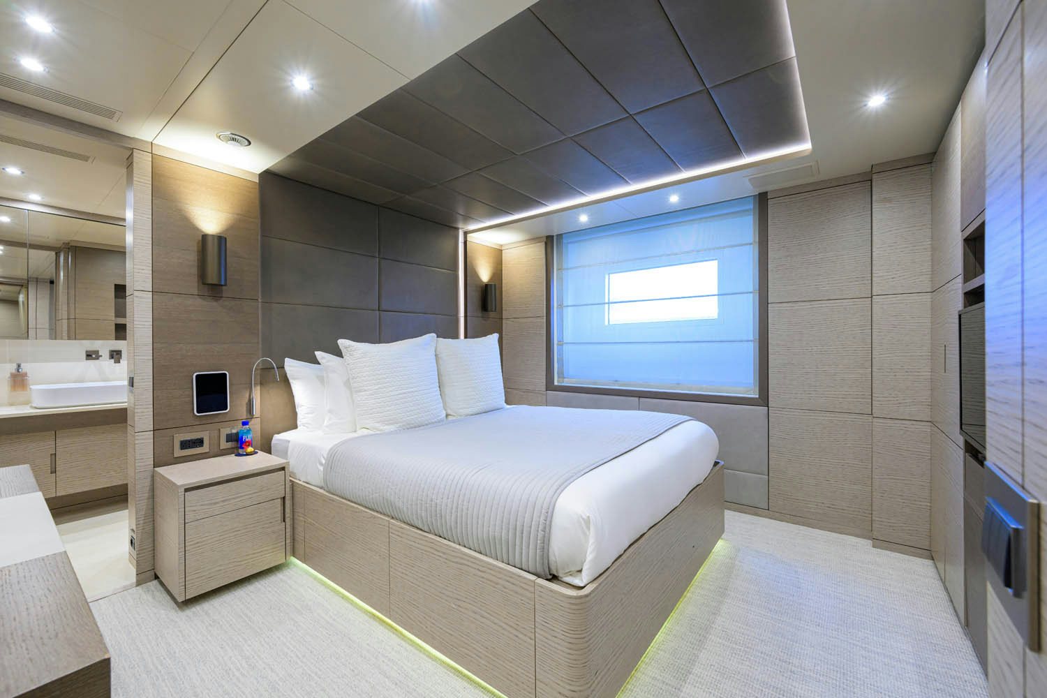 a large bedroom with a bed aboard COFINA Yacht for Charter