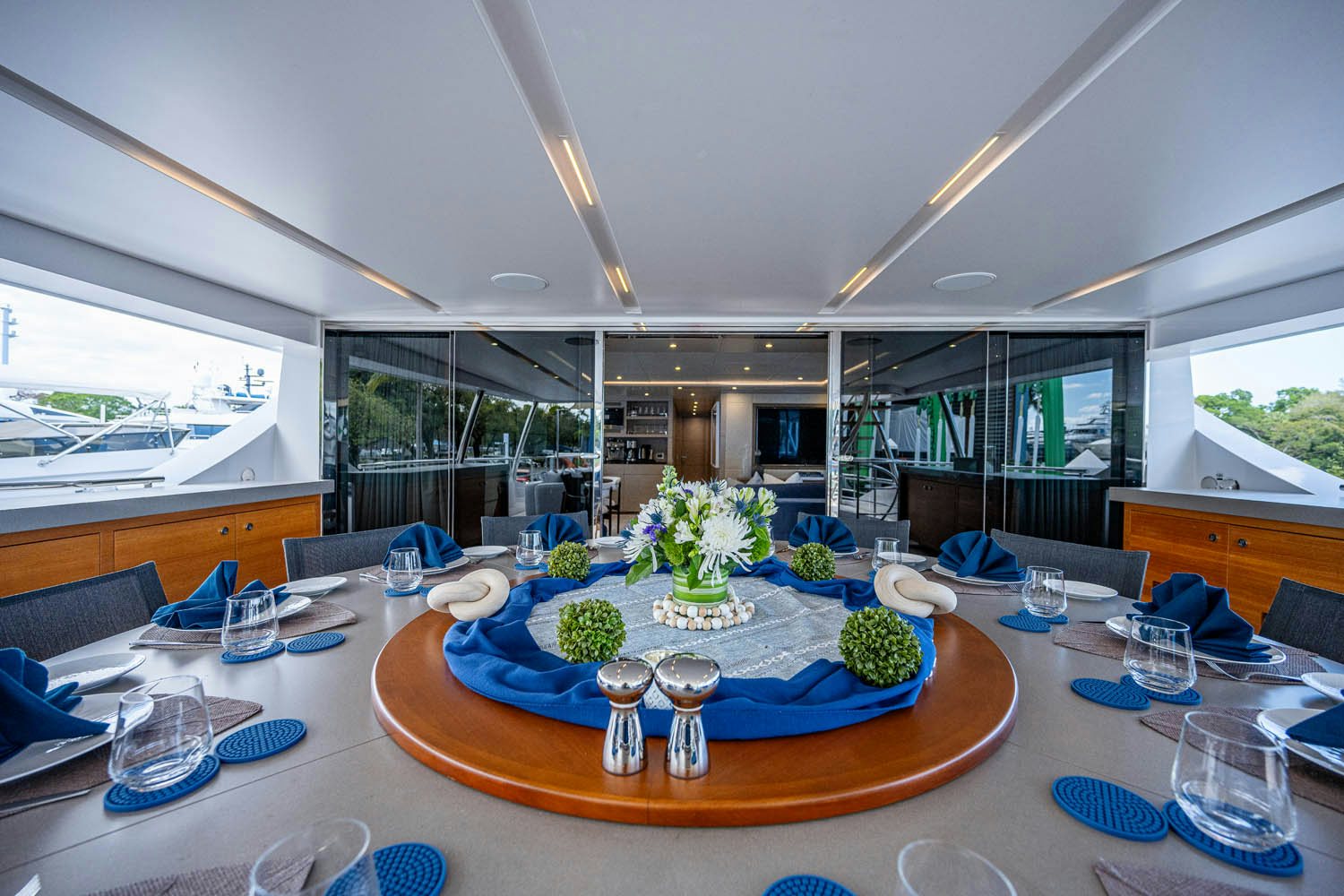a large dining table with a large window aboard COFINA Yacht for Charter