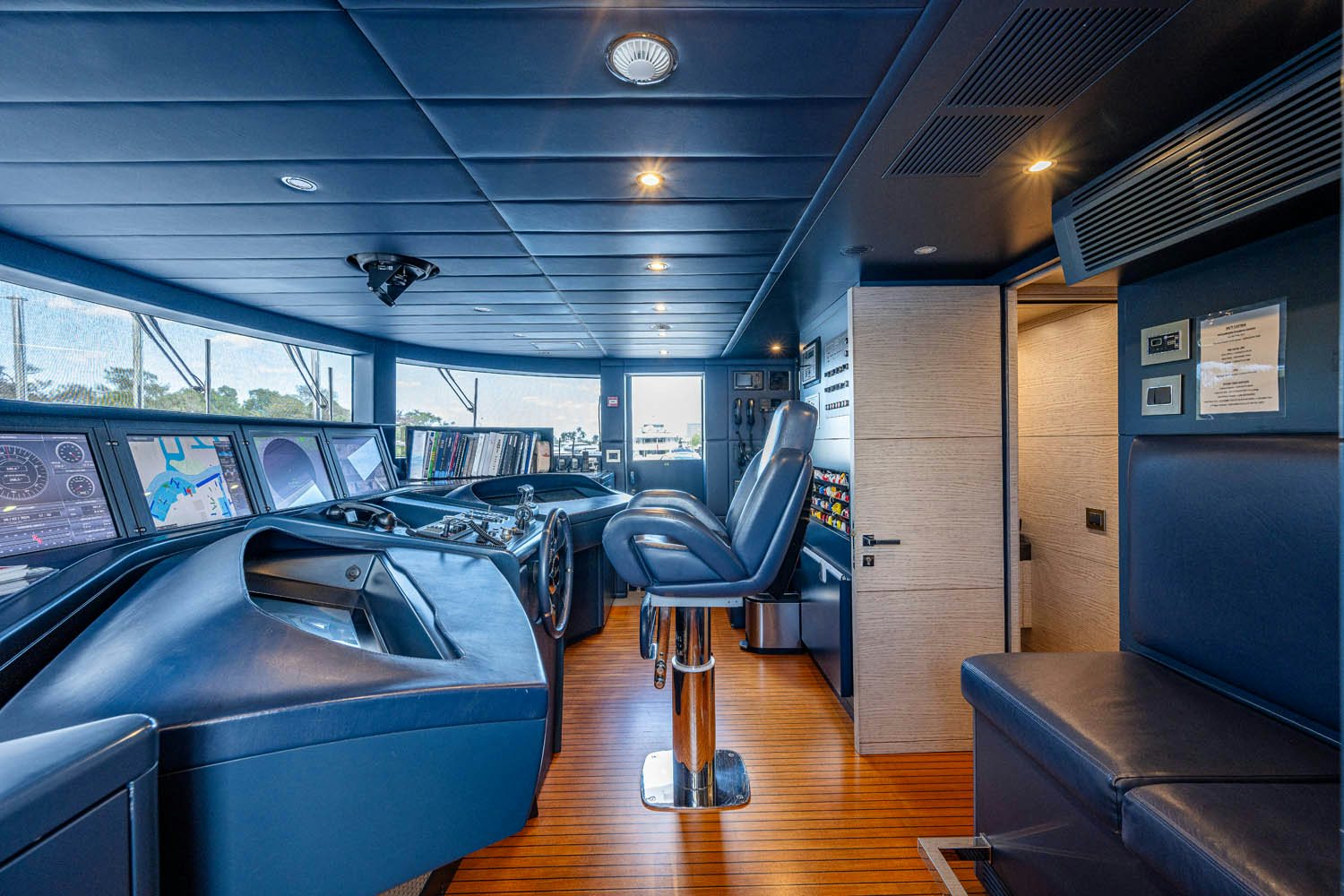 inside of a vehicle with seats and a table and chairs aboard COFINA Yacht for Charter