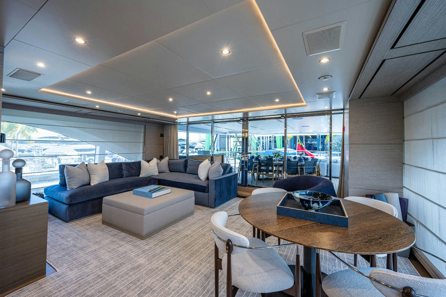 a living room with a large window aboard COFINA Yacht for Charter
