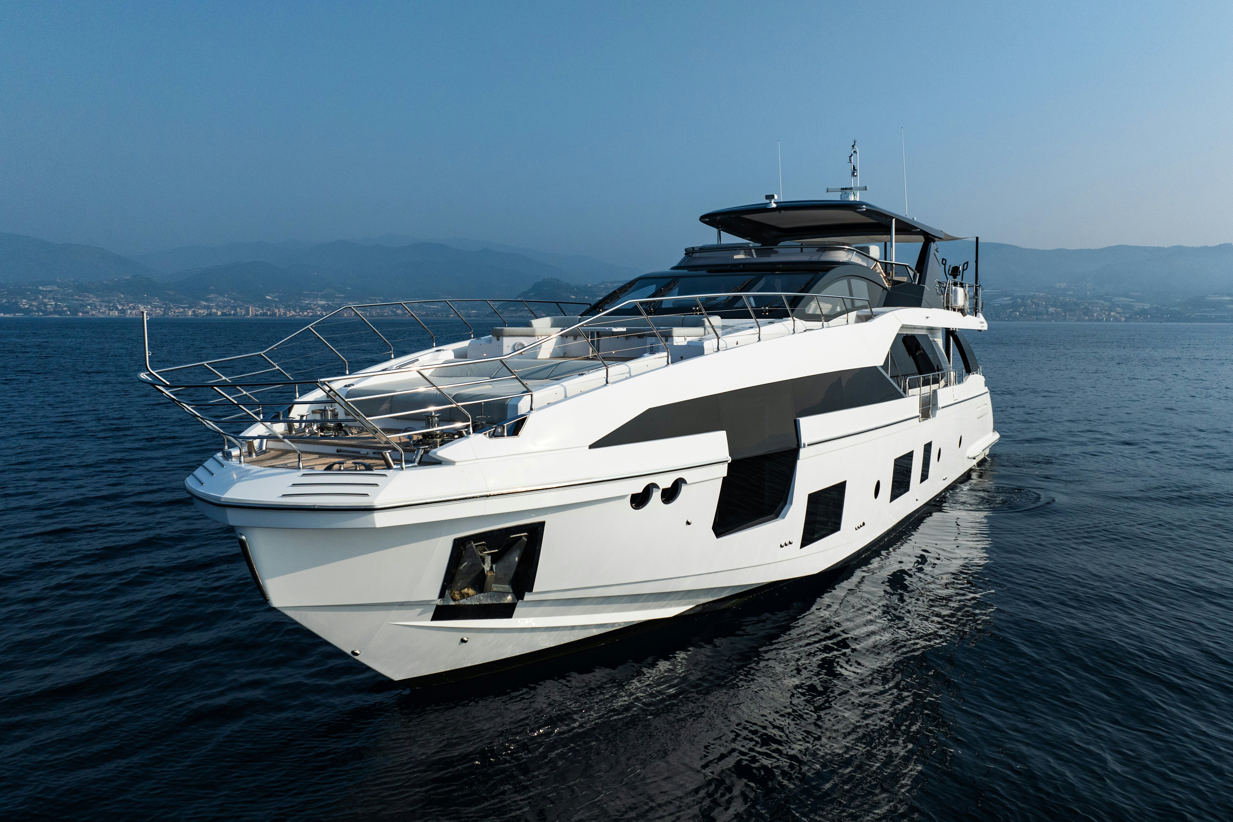 a white yacht on the water aboard CHILLIN’ Yacht for Sale