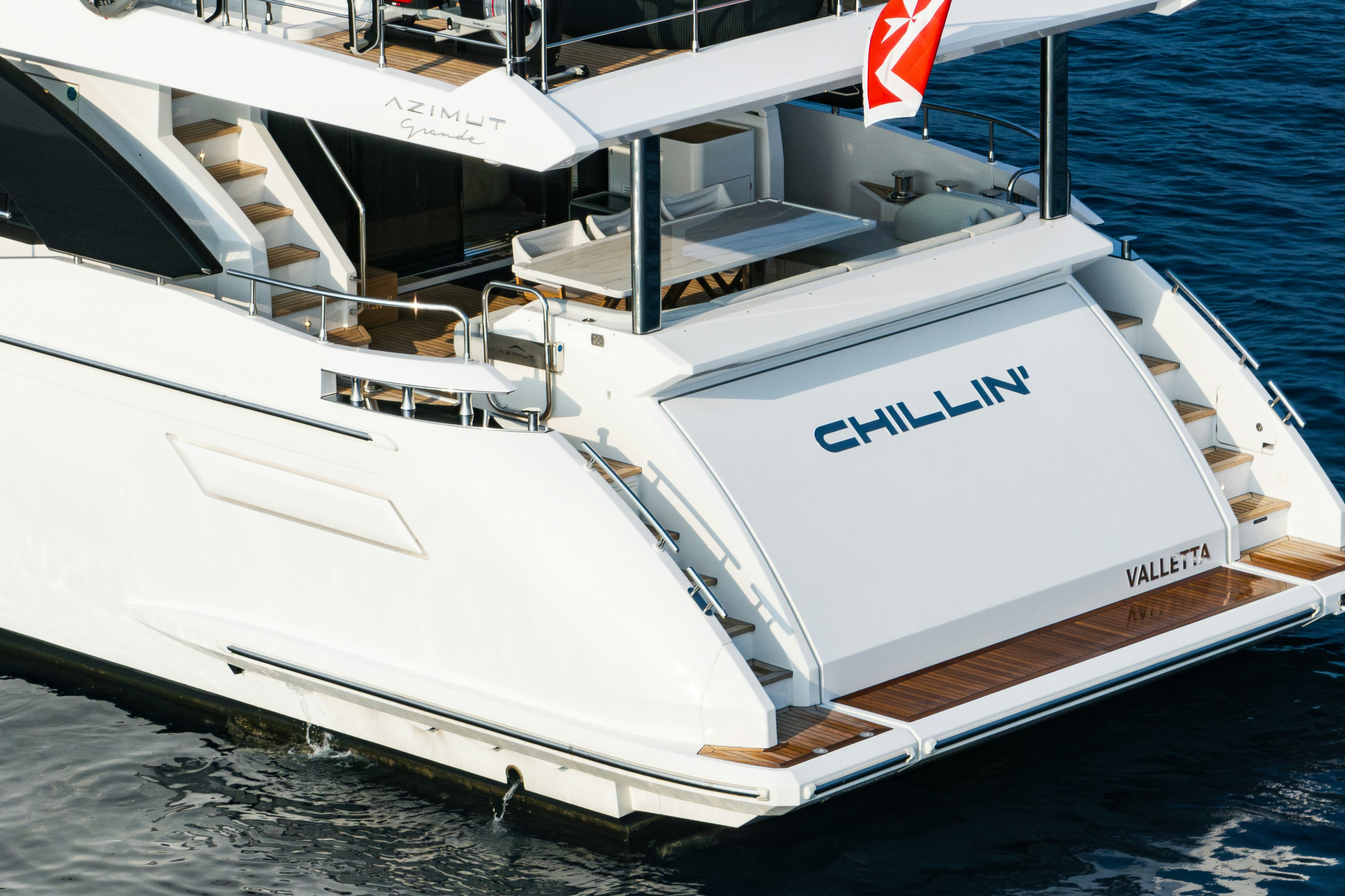 a white boat on the water aboard CHILLIN’ Yacht for Sale
