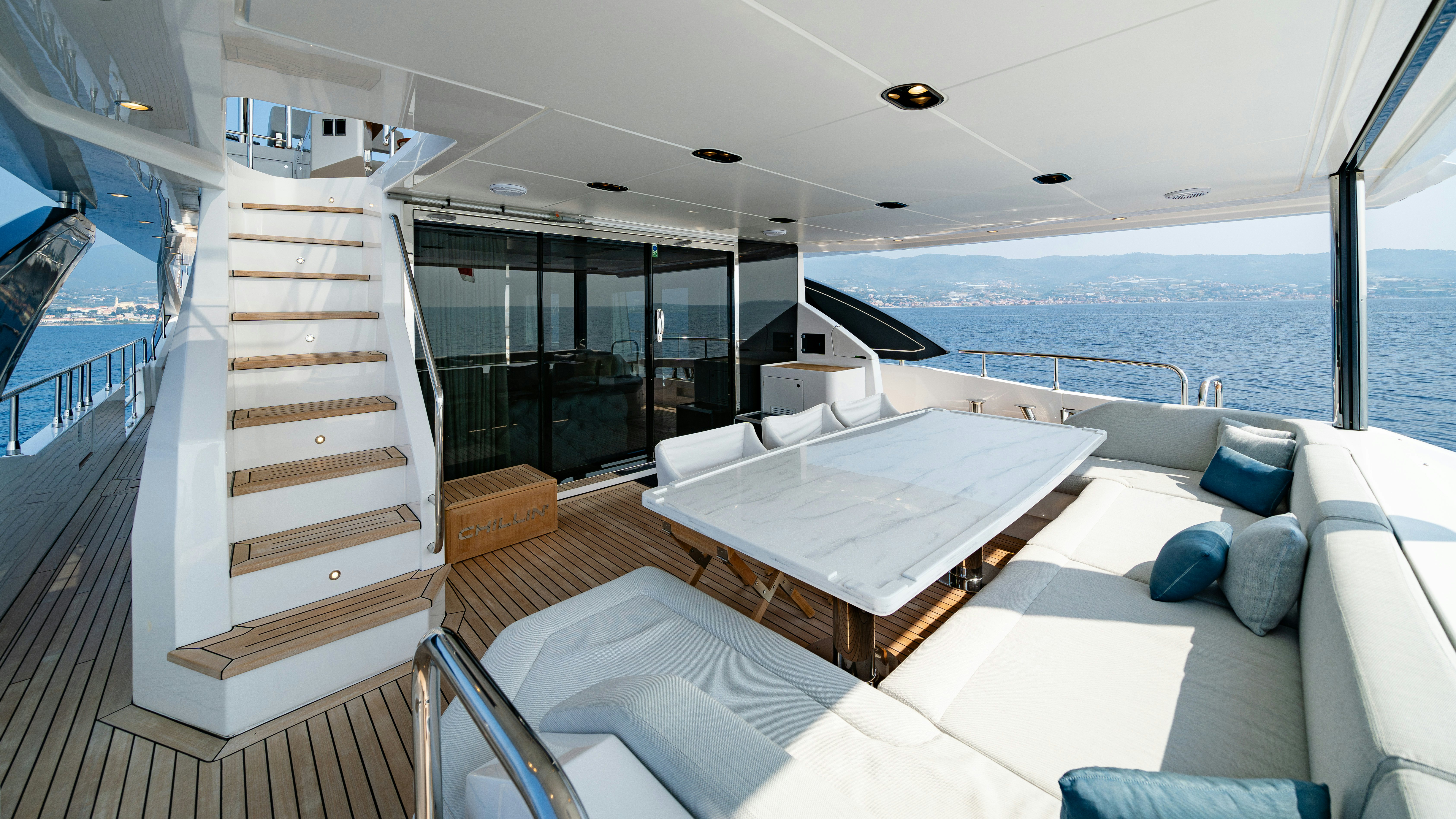 a room with a bed and a large window aboard CHILLIN’ Yacht for Sale