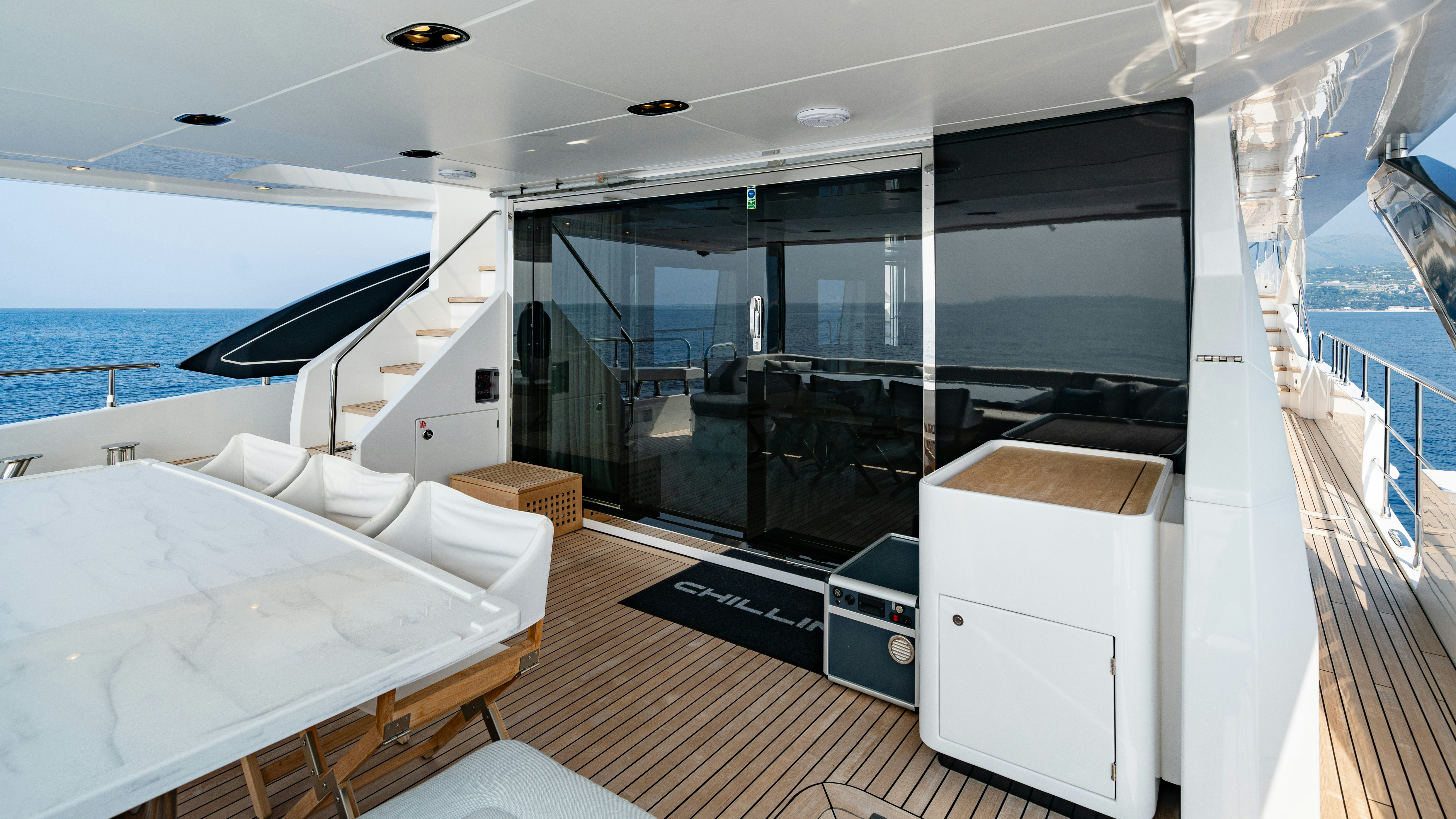 a room with a bed and a large window aboard CHILLIN’ Yacht for Sale