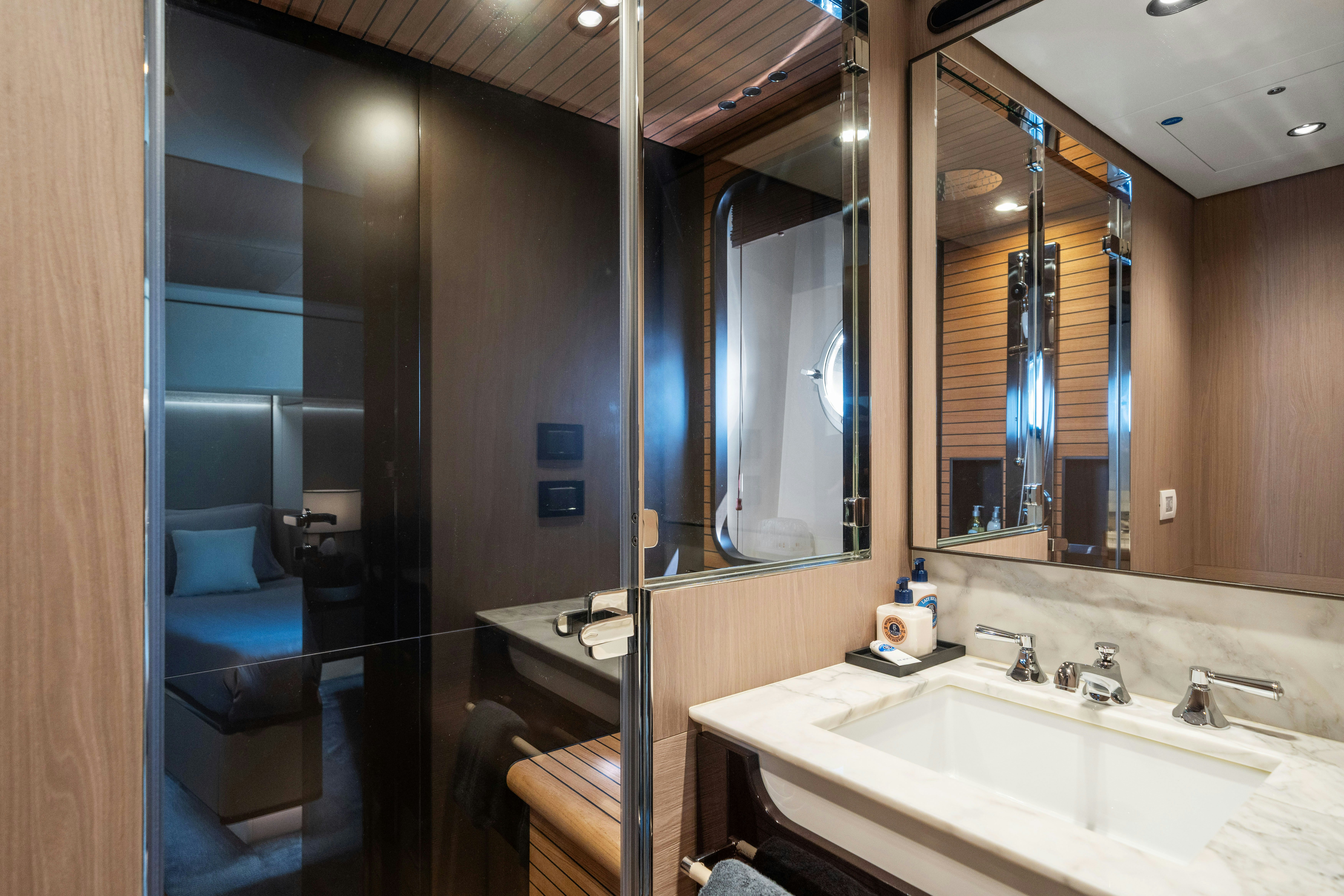 a bathroom with a large mirror aboard CHILLIN’ Yacht for Sale