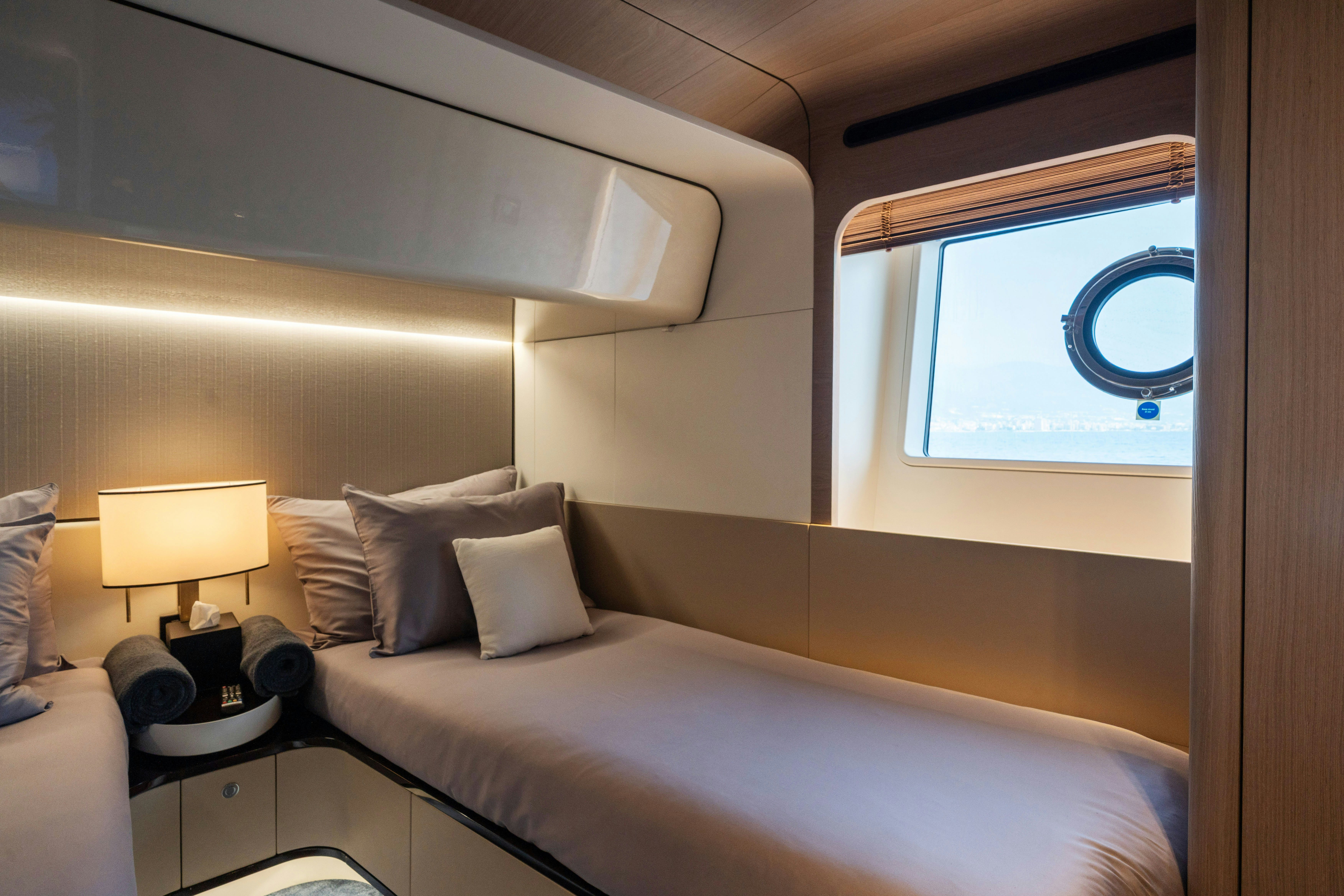a bed with a white bed spread aboard CHILLIN’ Yacht for Sale
