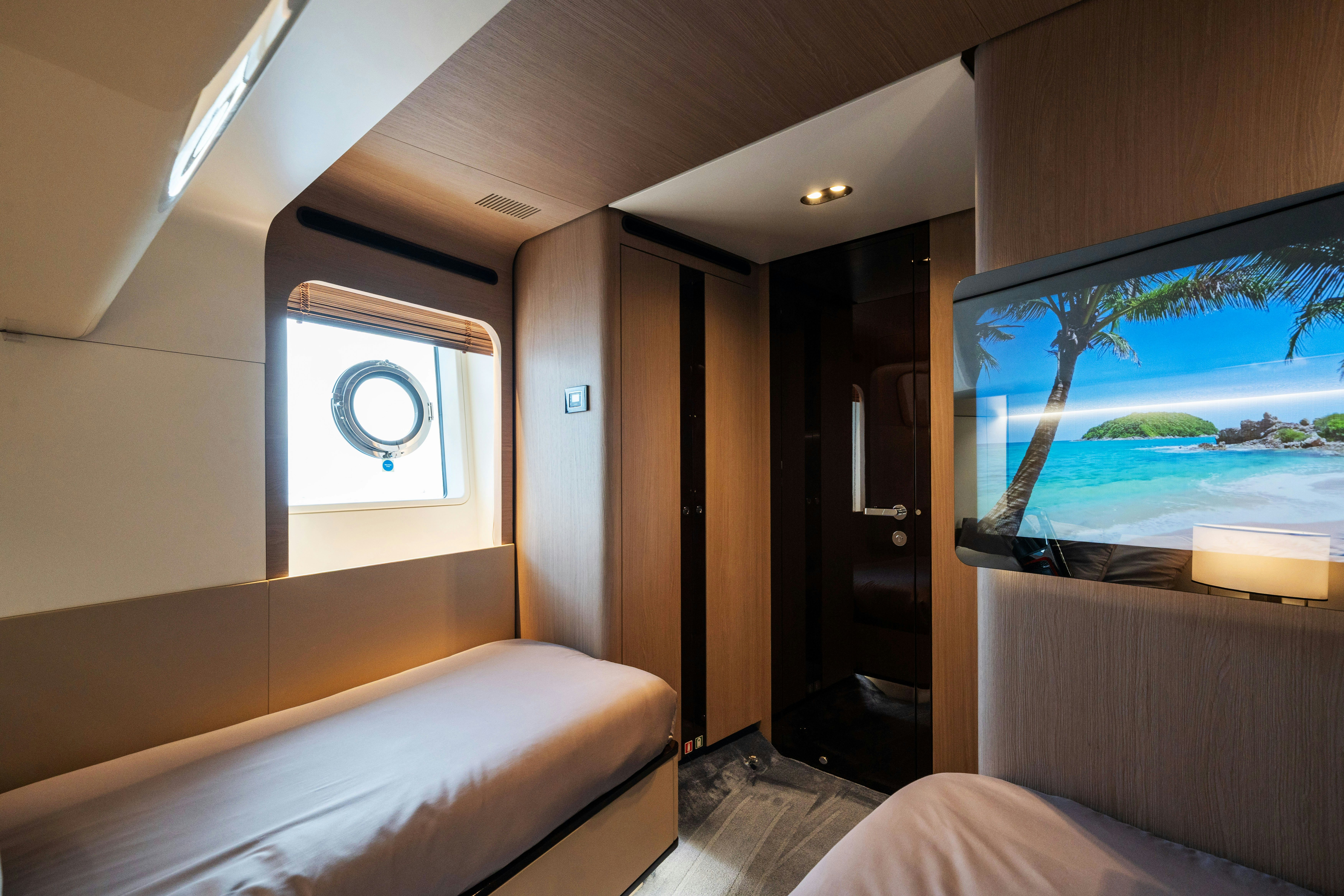 a room with a bed and a television aboard CHILLIN’ Yacht for Sale