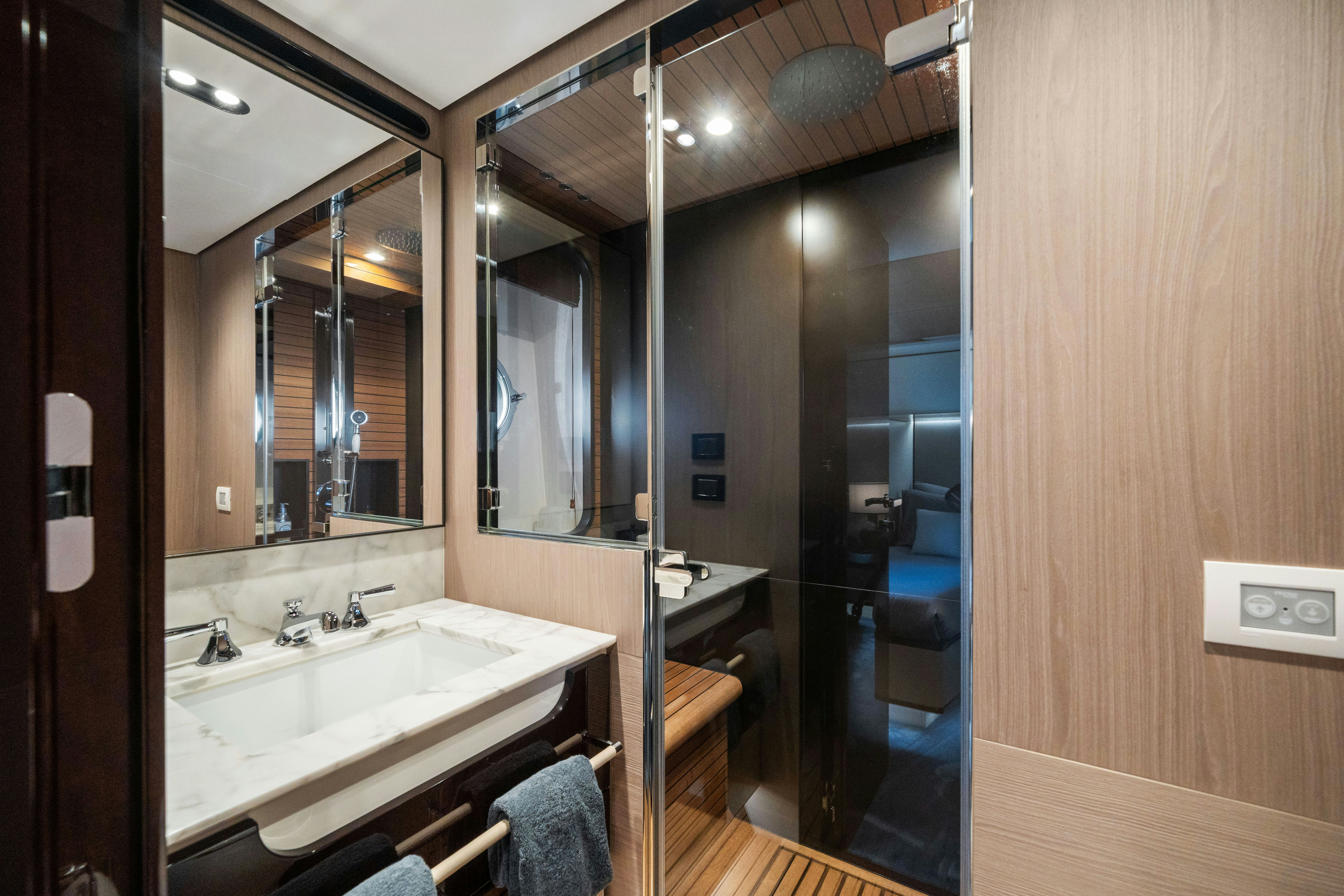a bathroom with a large mirror aboard CHILLIN’ Yacht for Sale