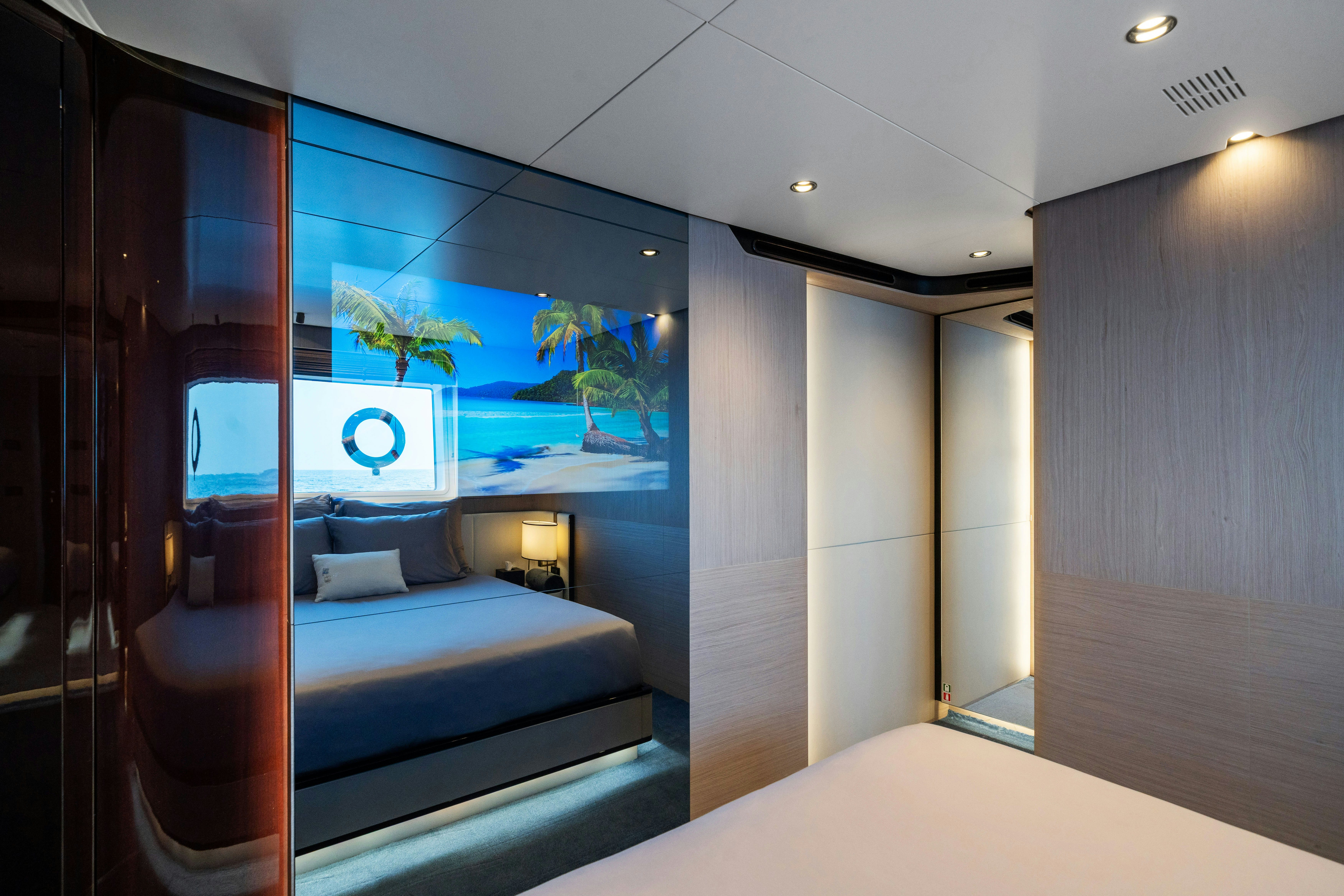 a room with a bed and a glass wall aboard CHILLIN’ Yacht for Sale