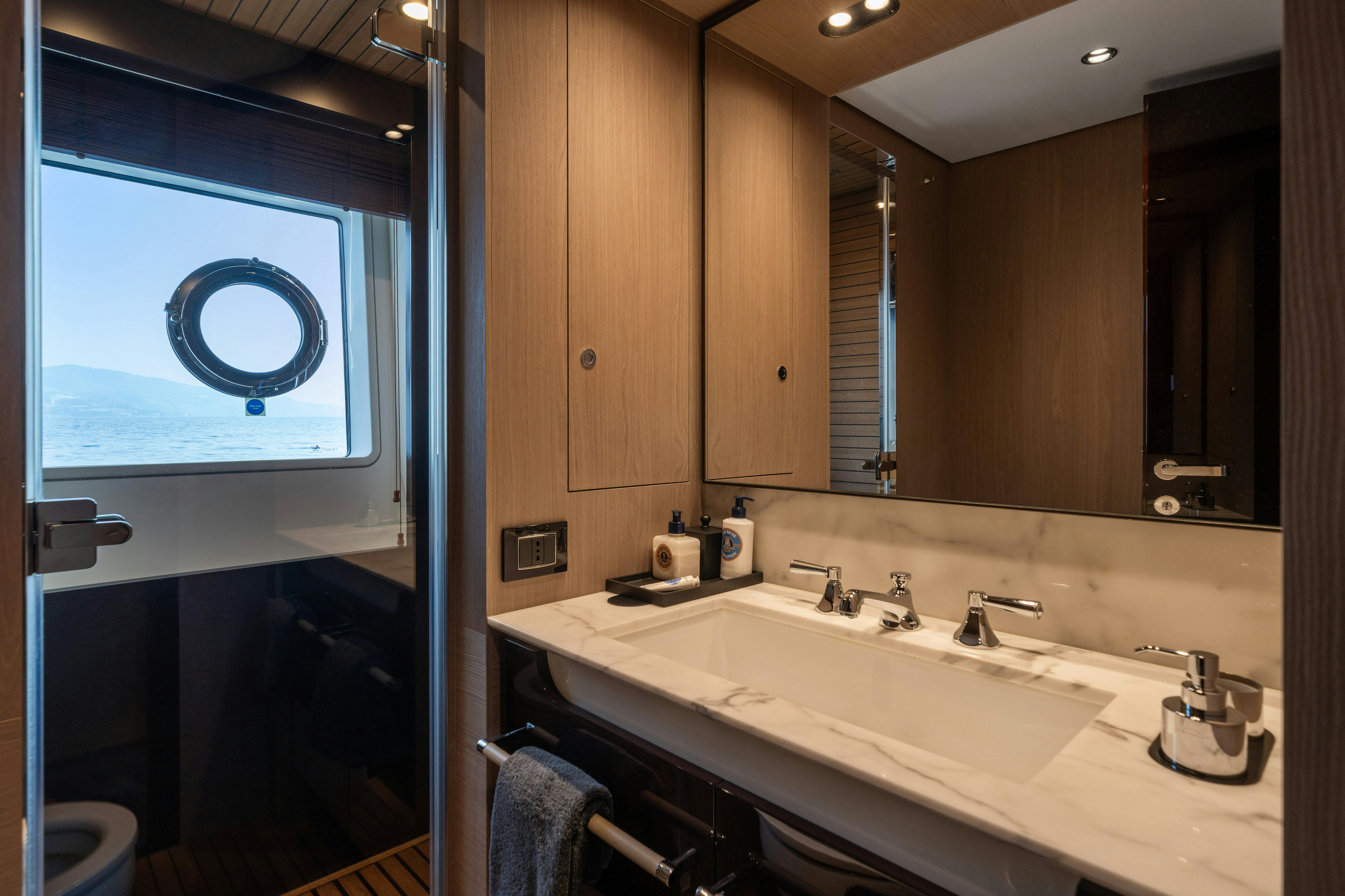 a bathroom with a large mirror aboard CHILLIN’ Yacht for Sale