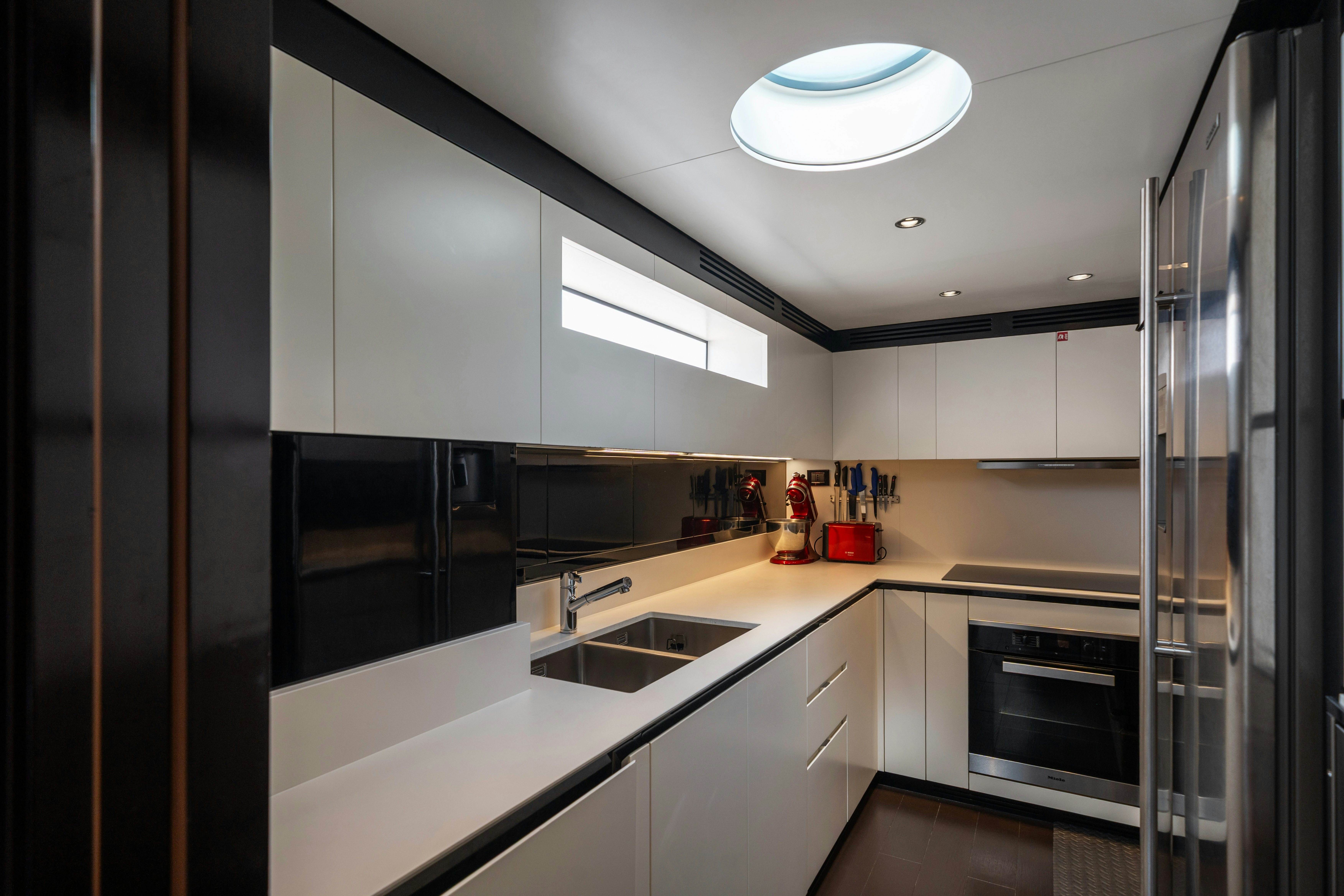 a kitchen with stainless steel appliances aboard CHILLIN’ Yacht for Sale