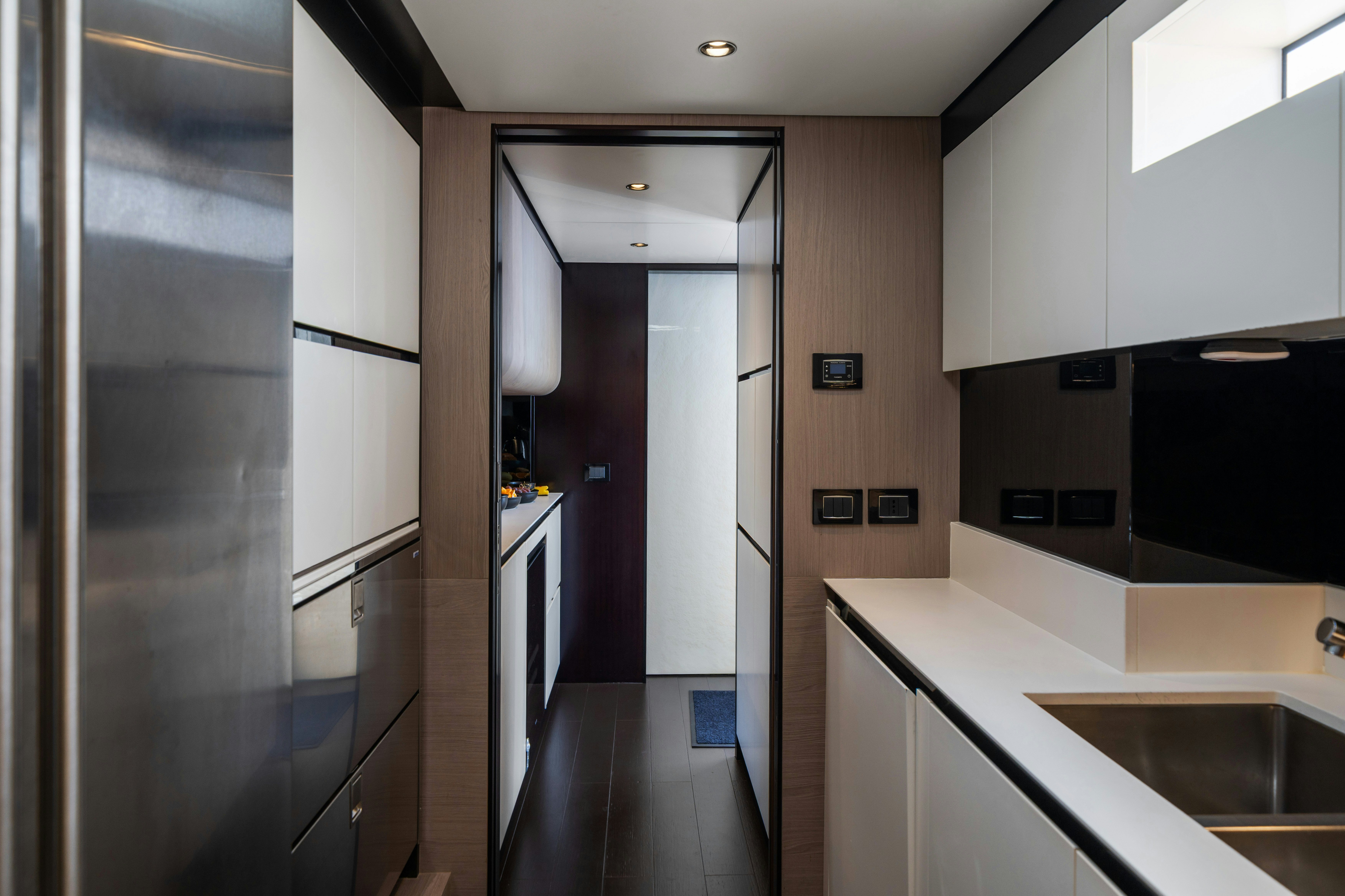 a kitchen with a large refrigerator aboard CHILLIN’ Yacht for Sale