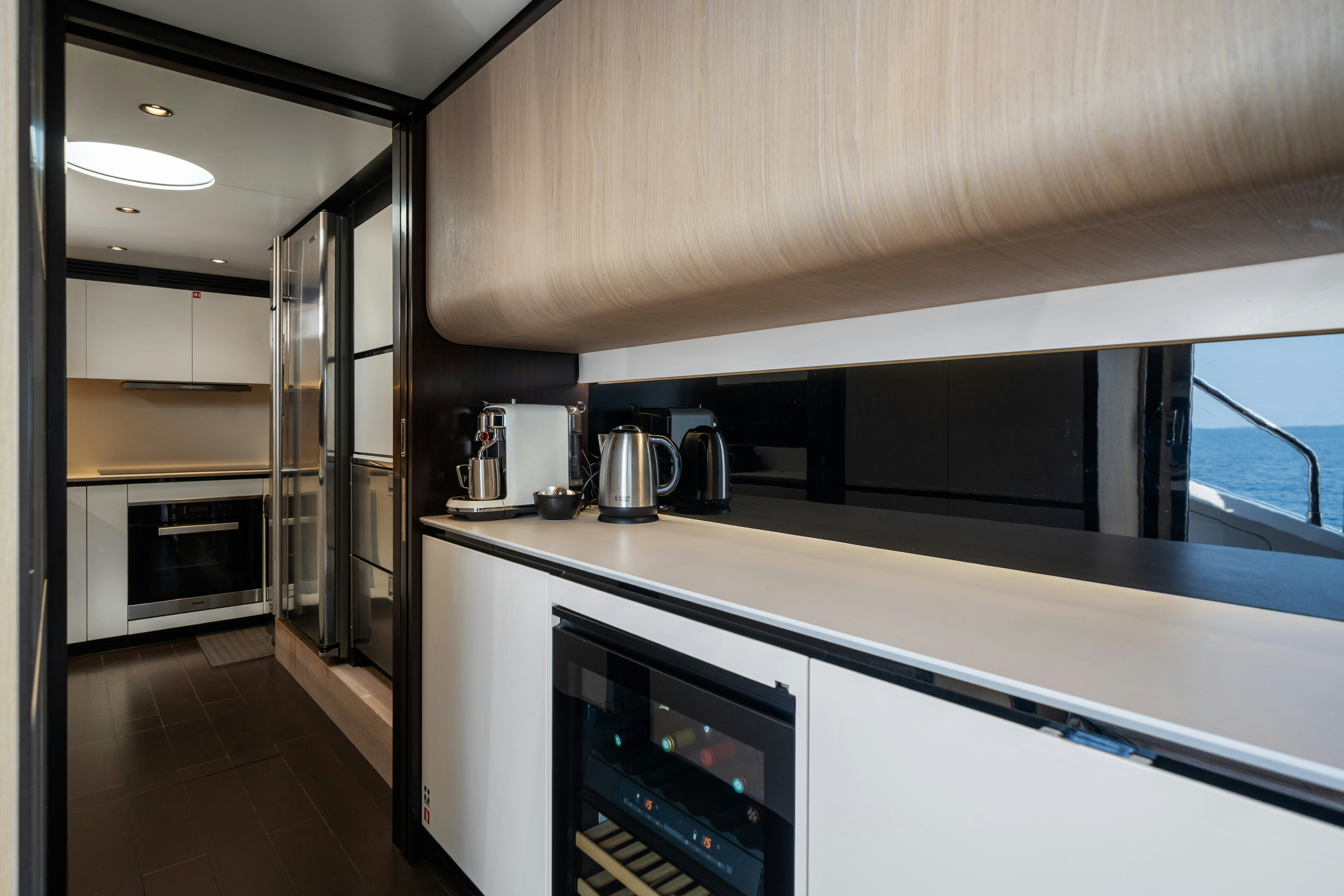 a kitchen with white cabinets aboard CHILLIN’ Yacht for Sale