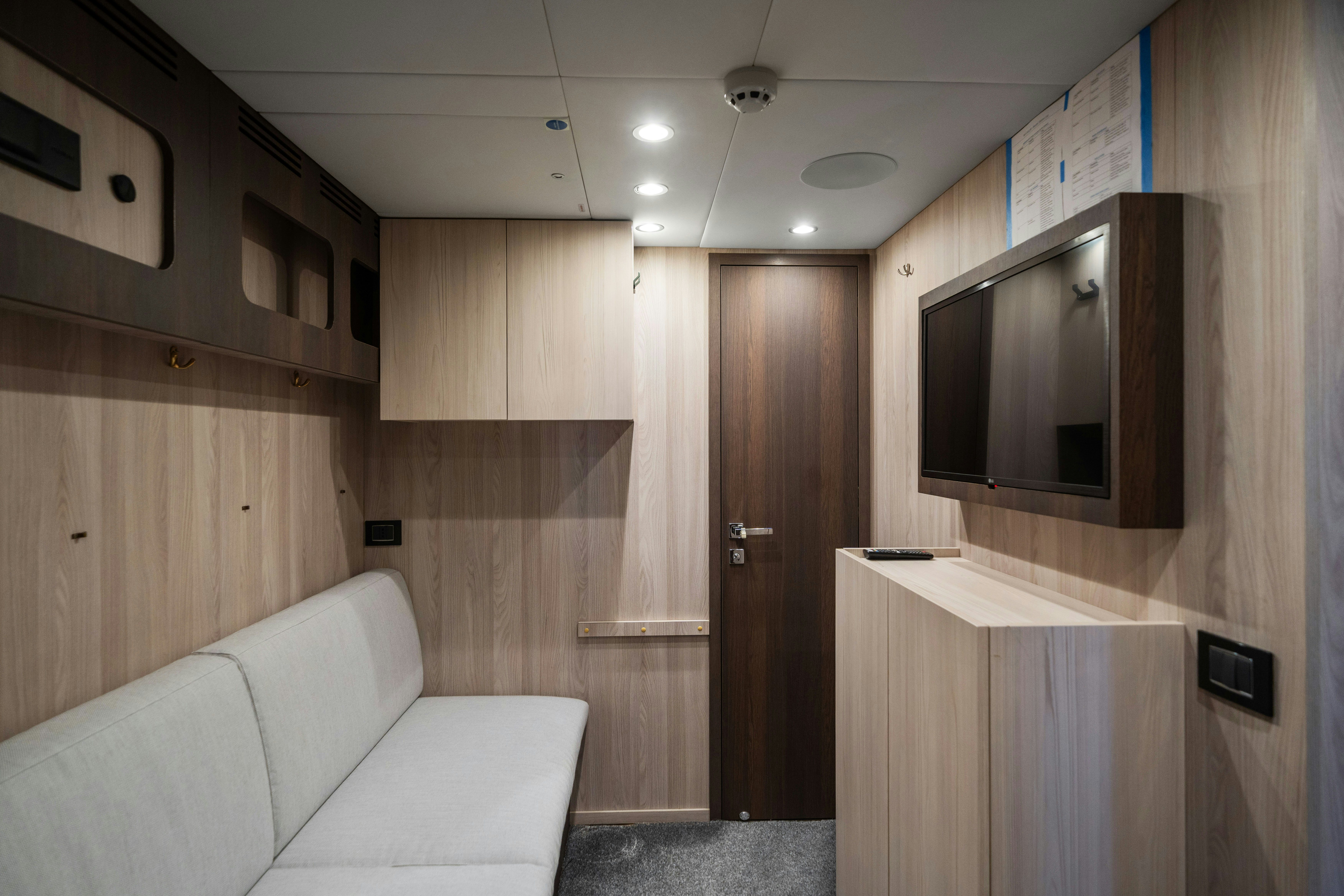 a room with a couch and a television aboard CHILLIN’ Yacht for Sale