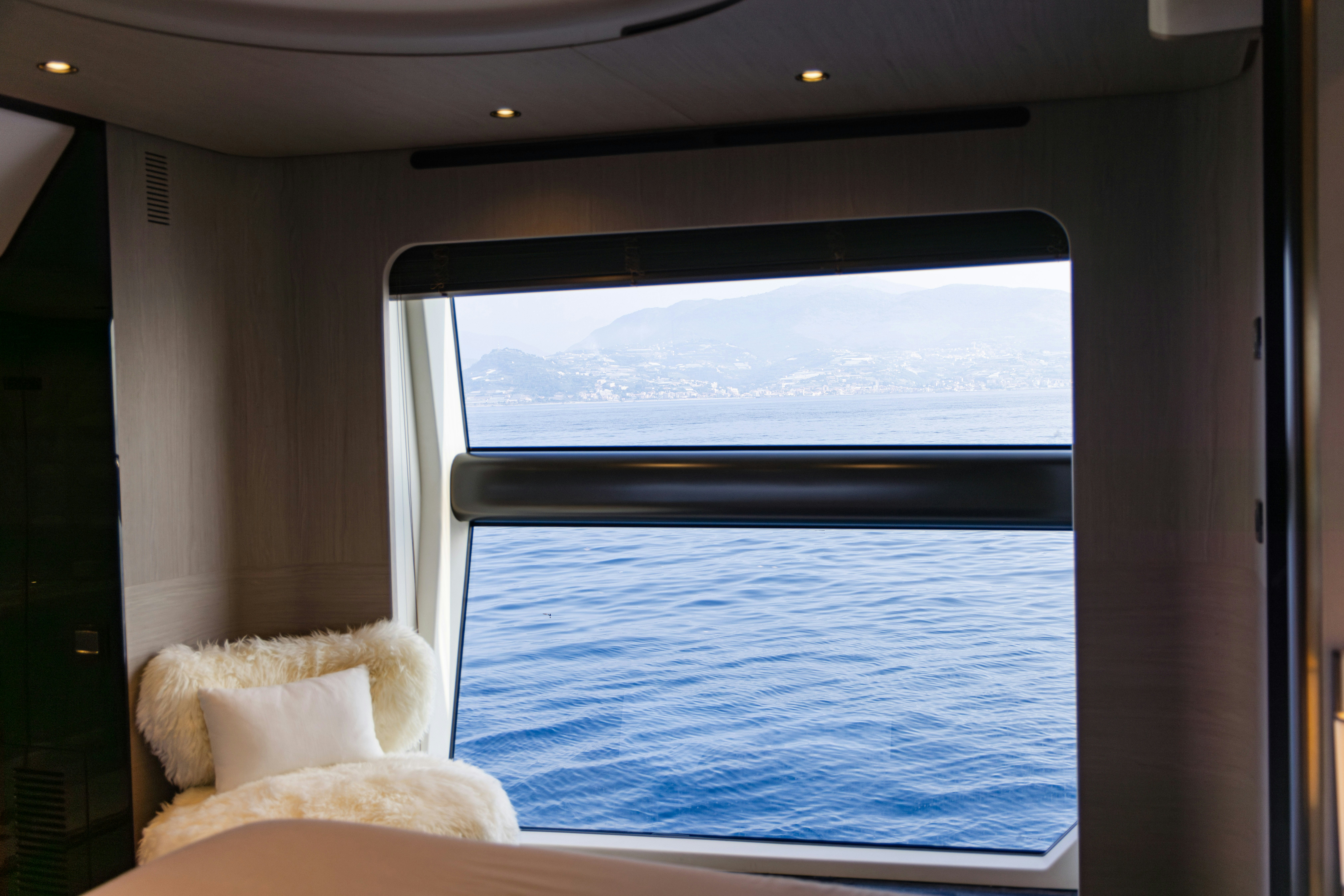 a view of a beach from a window aboard CHILLIN’ Yacht for Sale