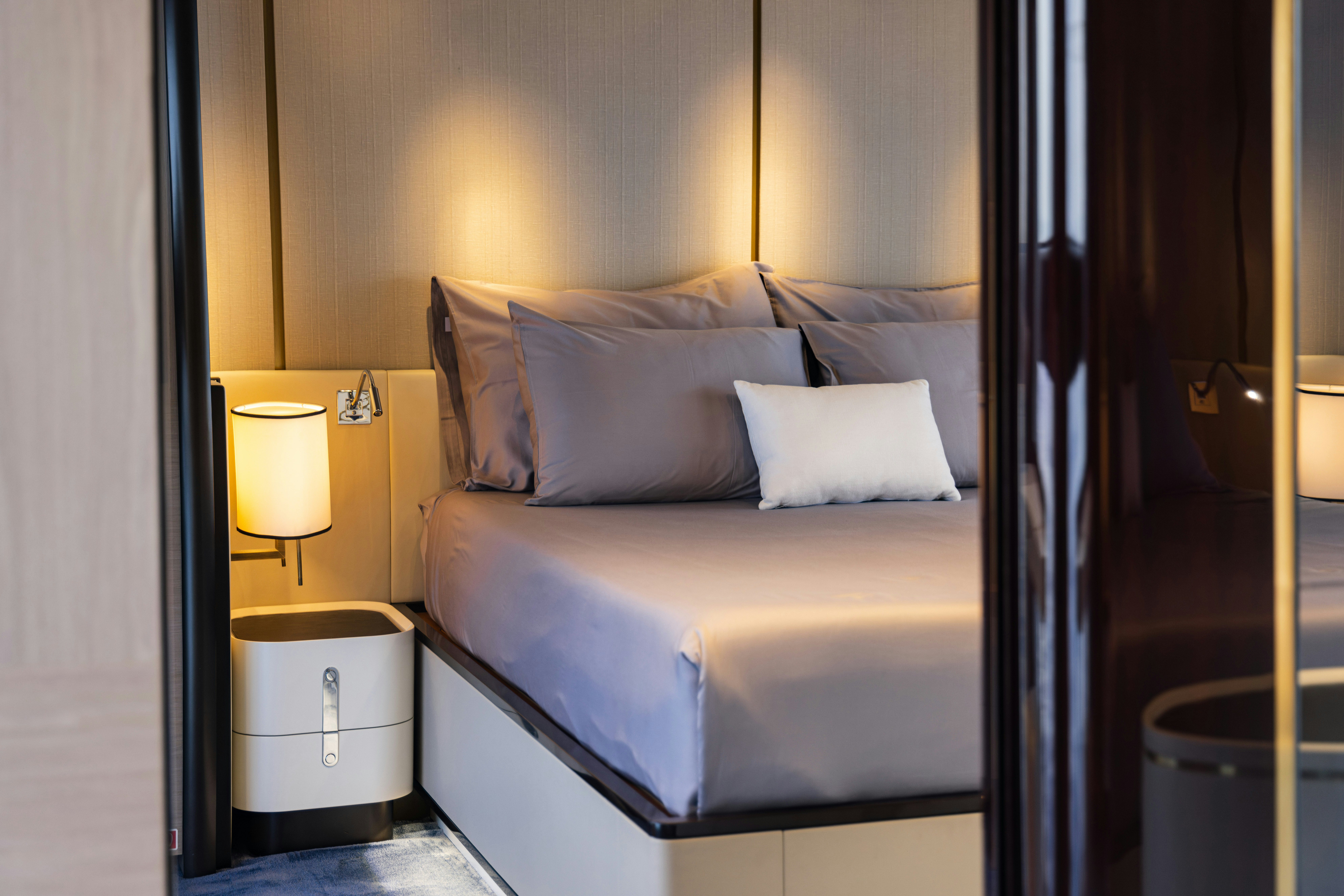 a bed with a white sheet aboard CHILLIN’ Yacht for Sale