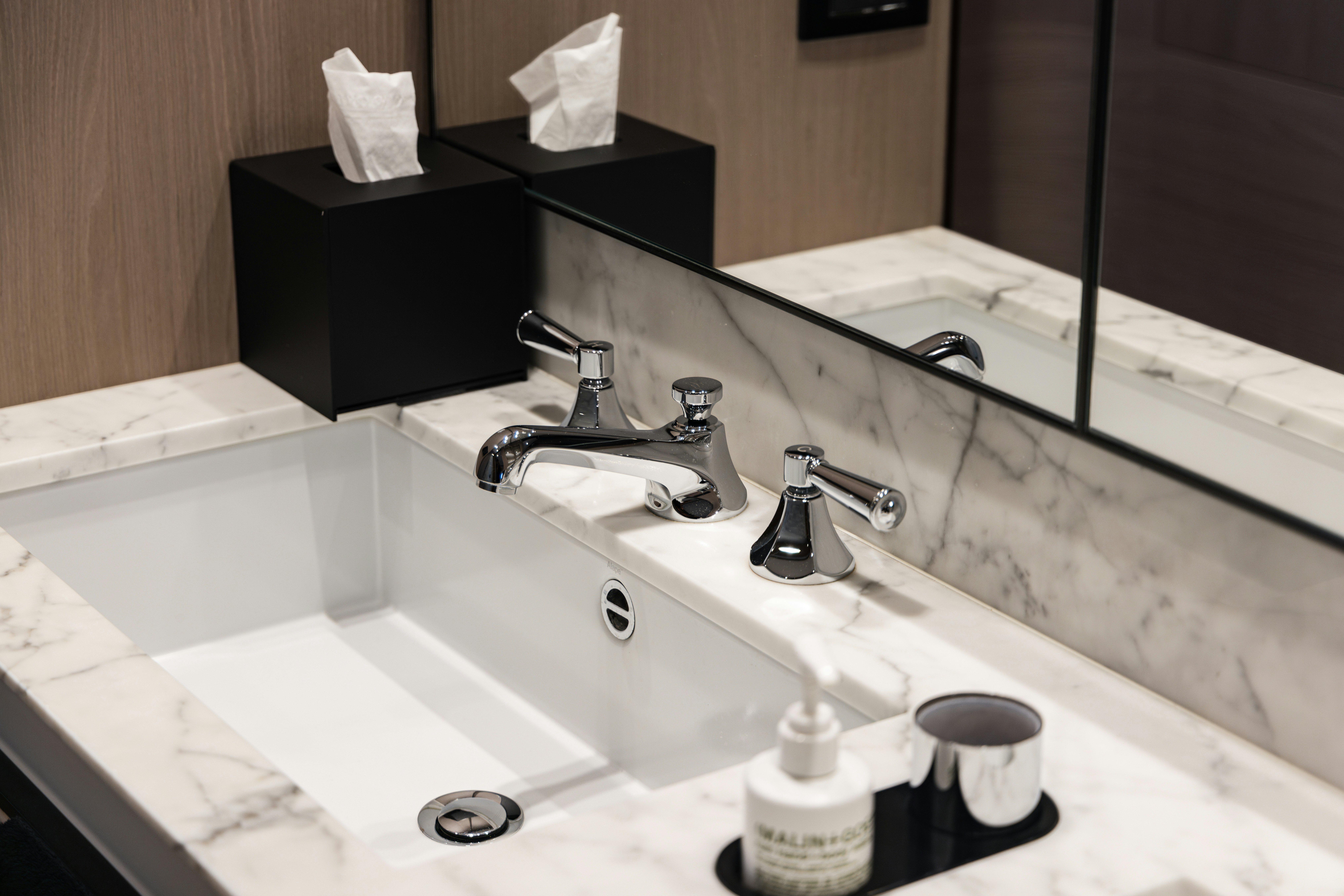 a bathroom sink with a mirror aboard CHILLIN’ Yacht for Sale