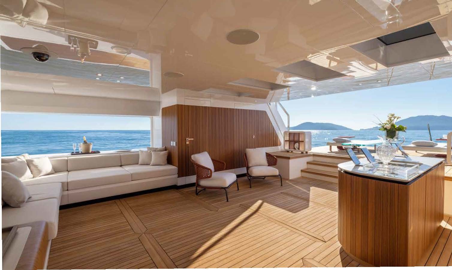 a room with a couch and a table and a large window aboard MANGUSTA OCEANO 44/08 Yacht for Sale