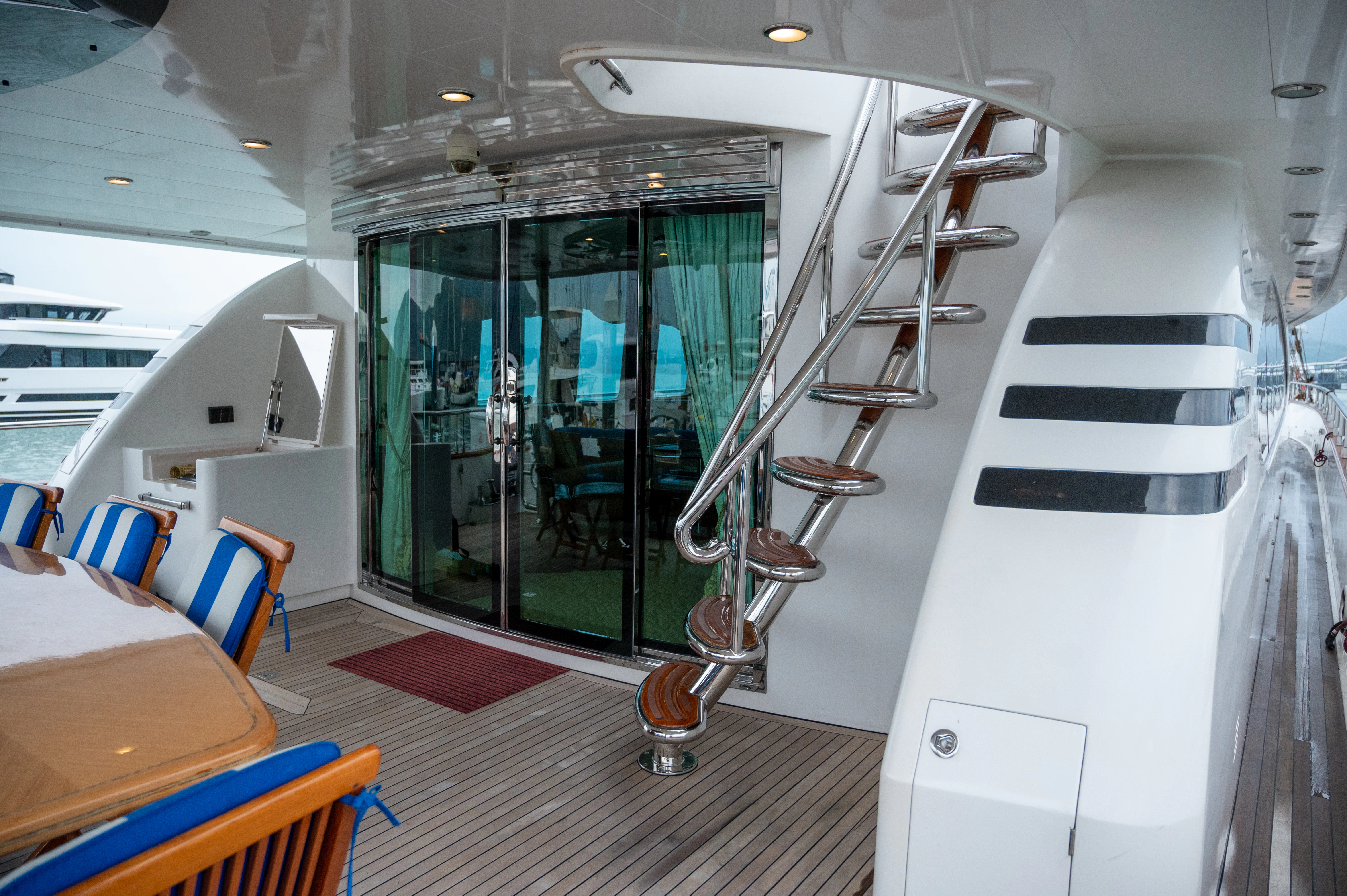 a room with a staircase and chairs aboard LADY EILEEN II Yacht for Sale