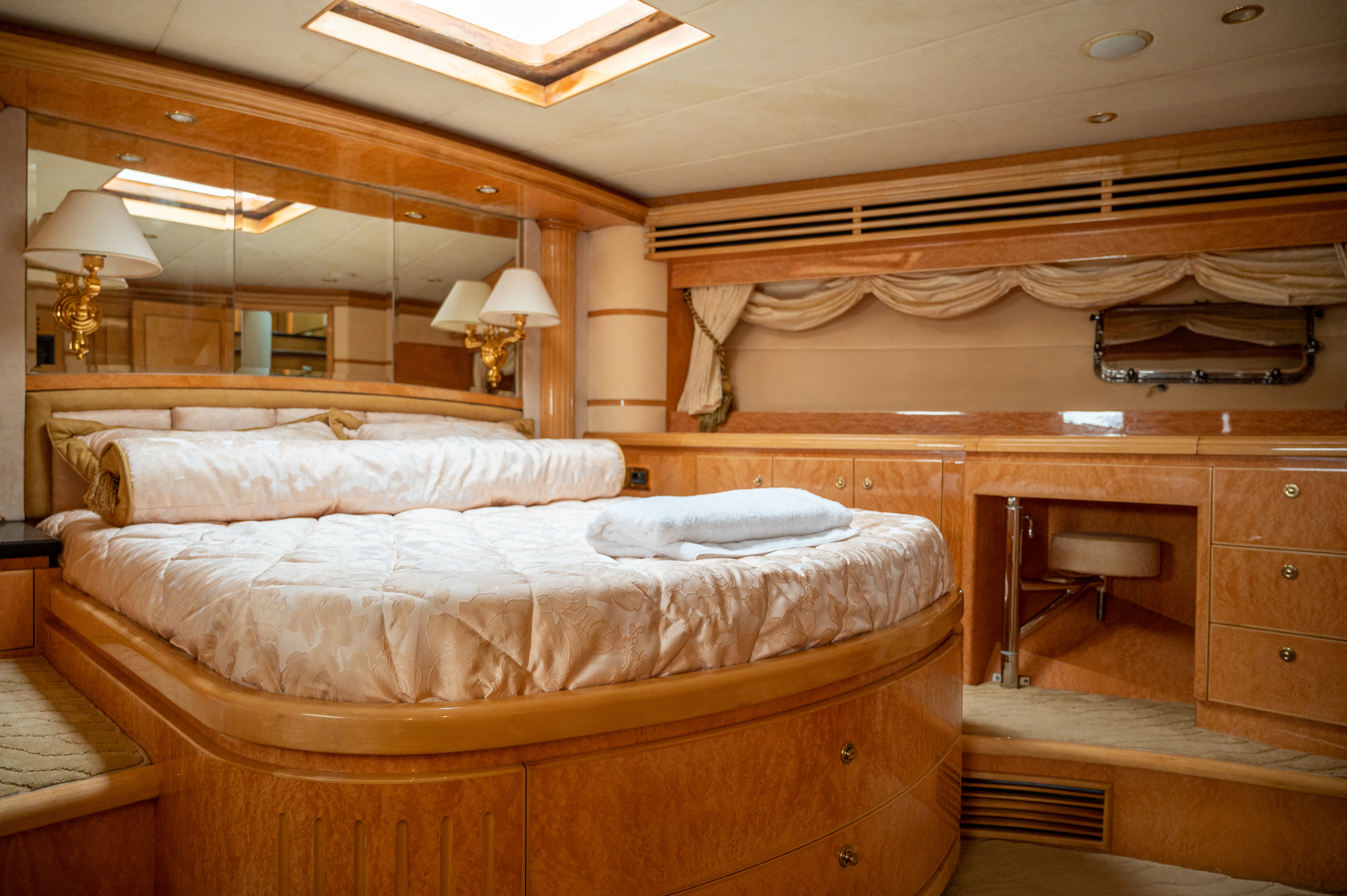 a room with a bed and a desk aboard LADY EILEEN II Yacht for Sale