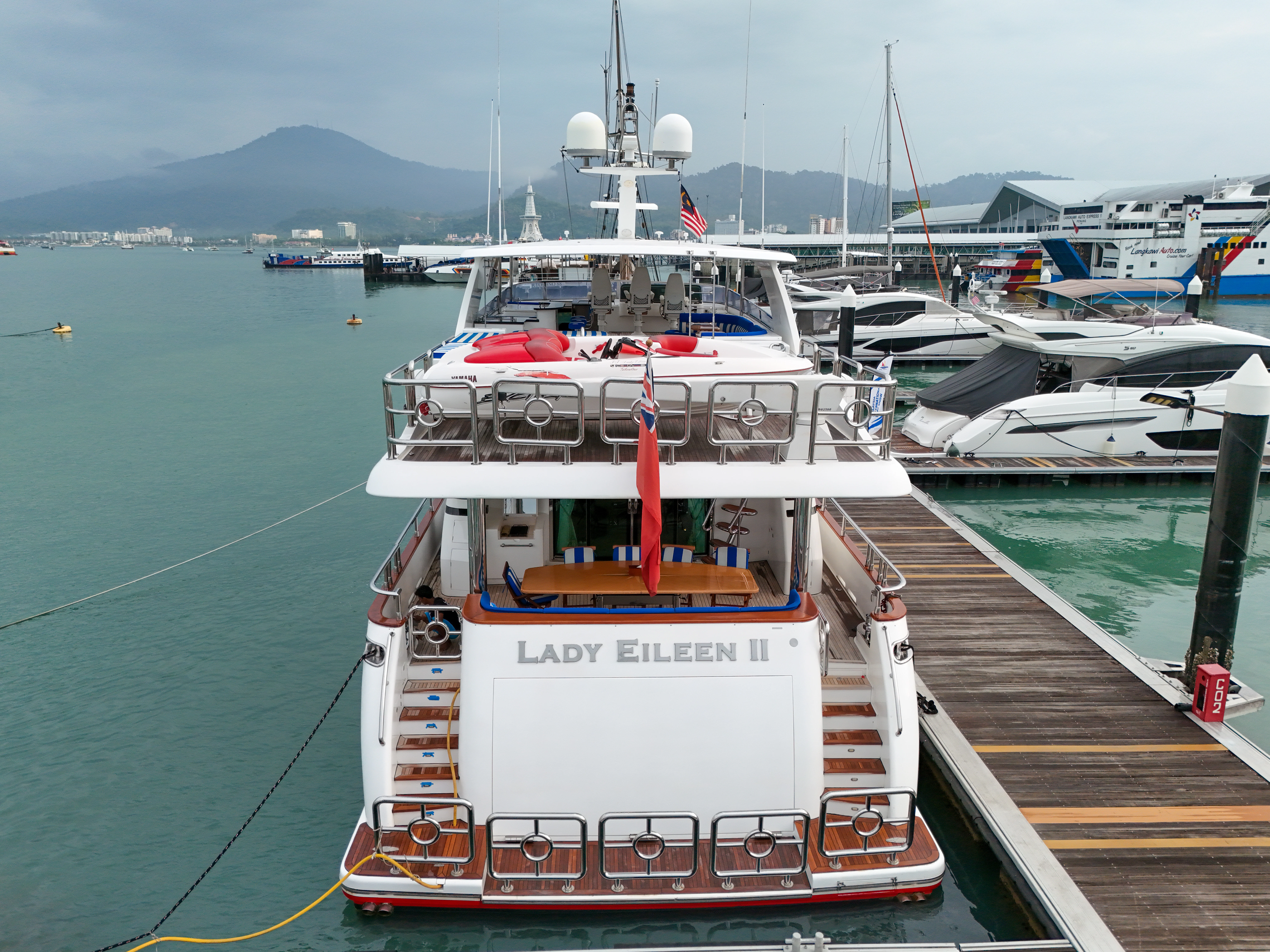a large white boat sits at the dock aboard LADY EILEEN II Yacht for Sale
